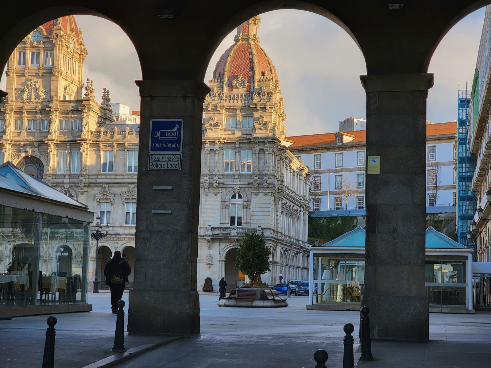 A Coruña — a couple of people that are standing in front of some buildings