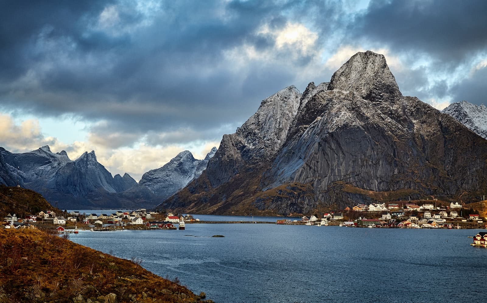 Å i Lofoten — body of water near rock mountain under cloudy skies