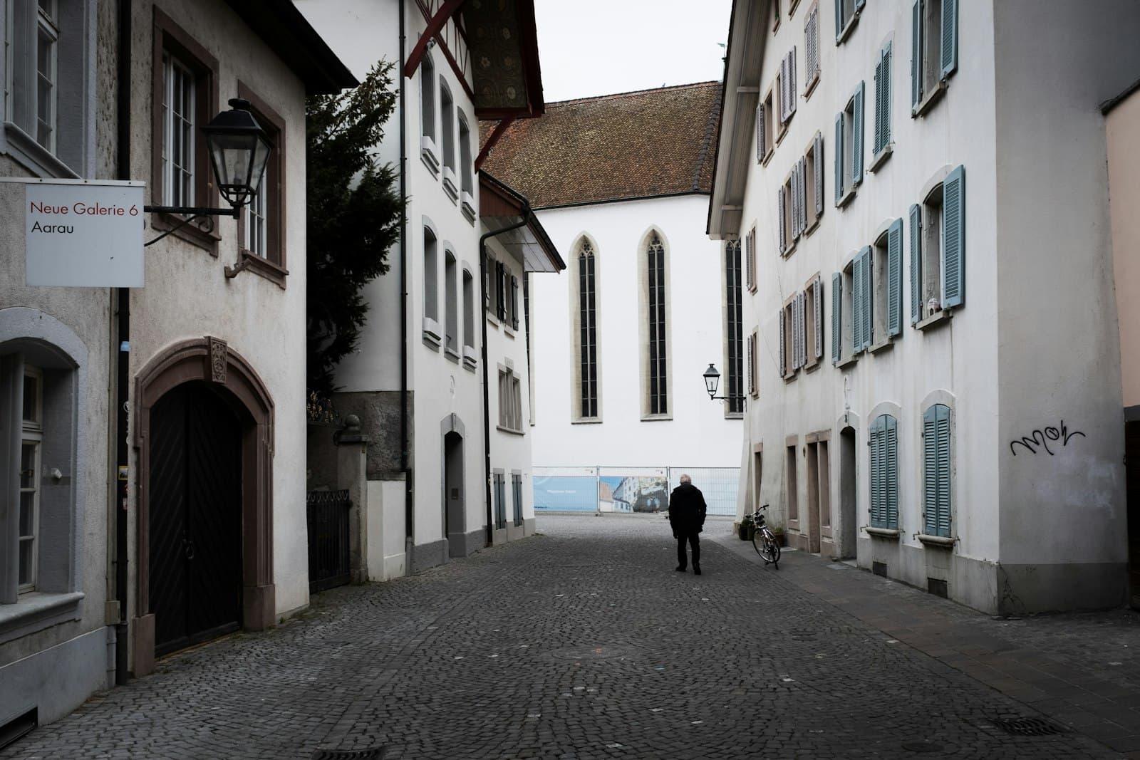 Aarau — A person walks down a stone alley.