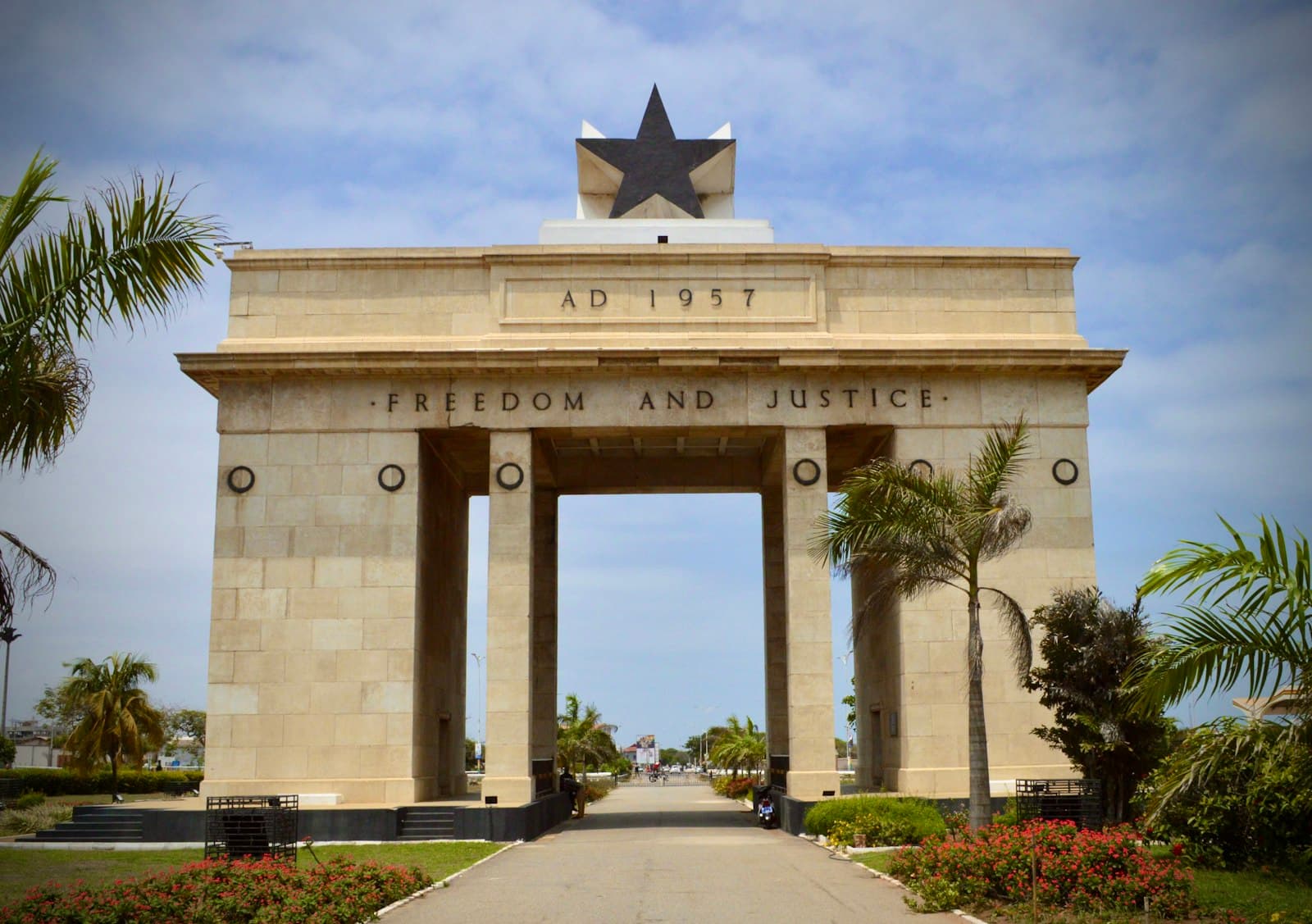 Accra — white concrete building with flag on top during daytime