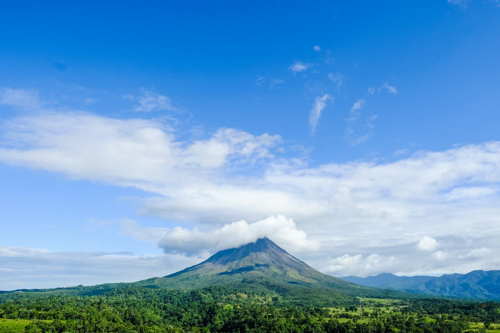 Alajuela — green mountain under blue sky and white clouds during daytime