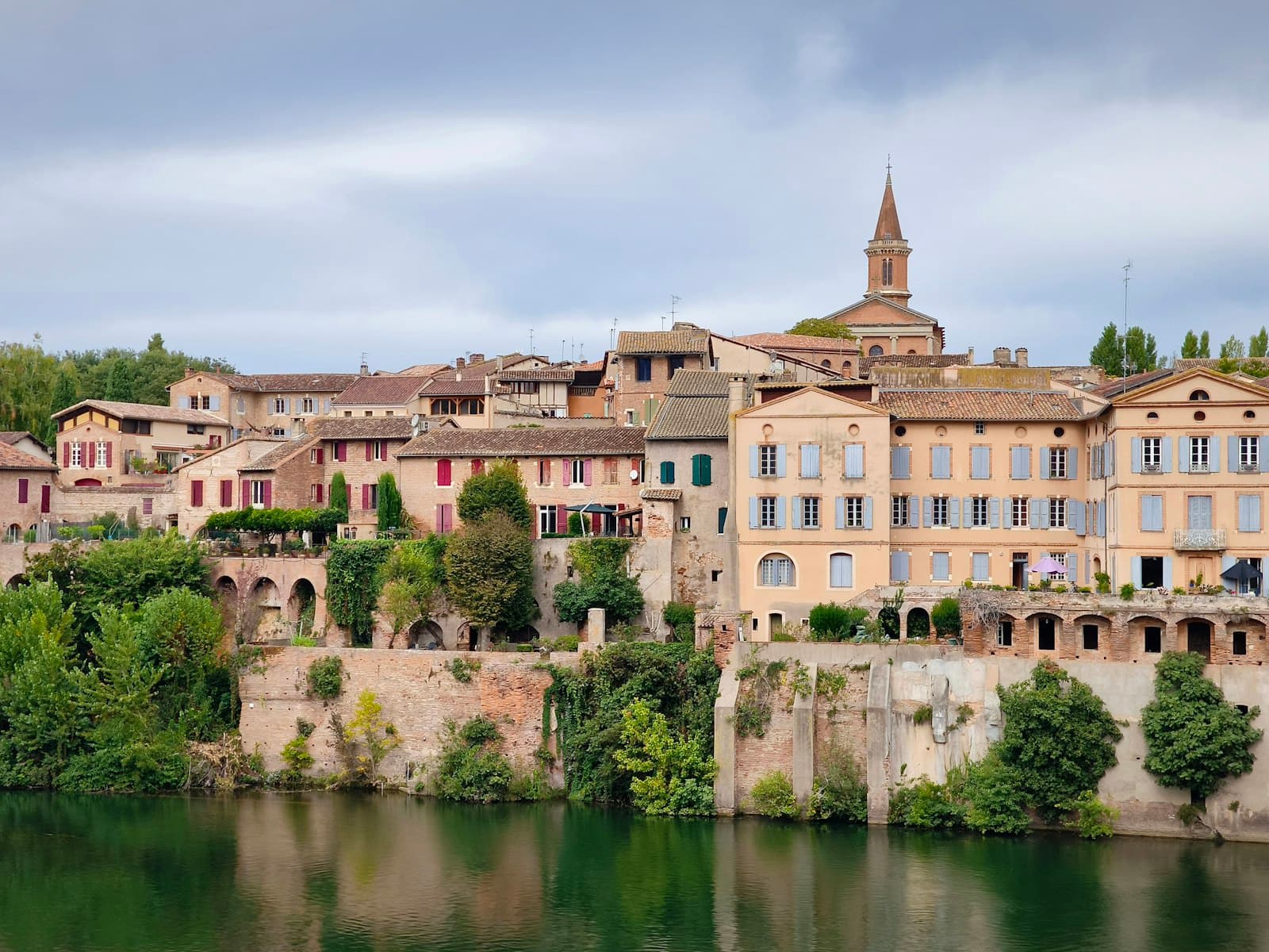 Albi — Historic european town on a river under cloudy sky