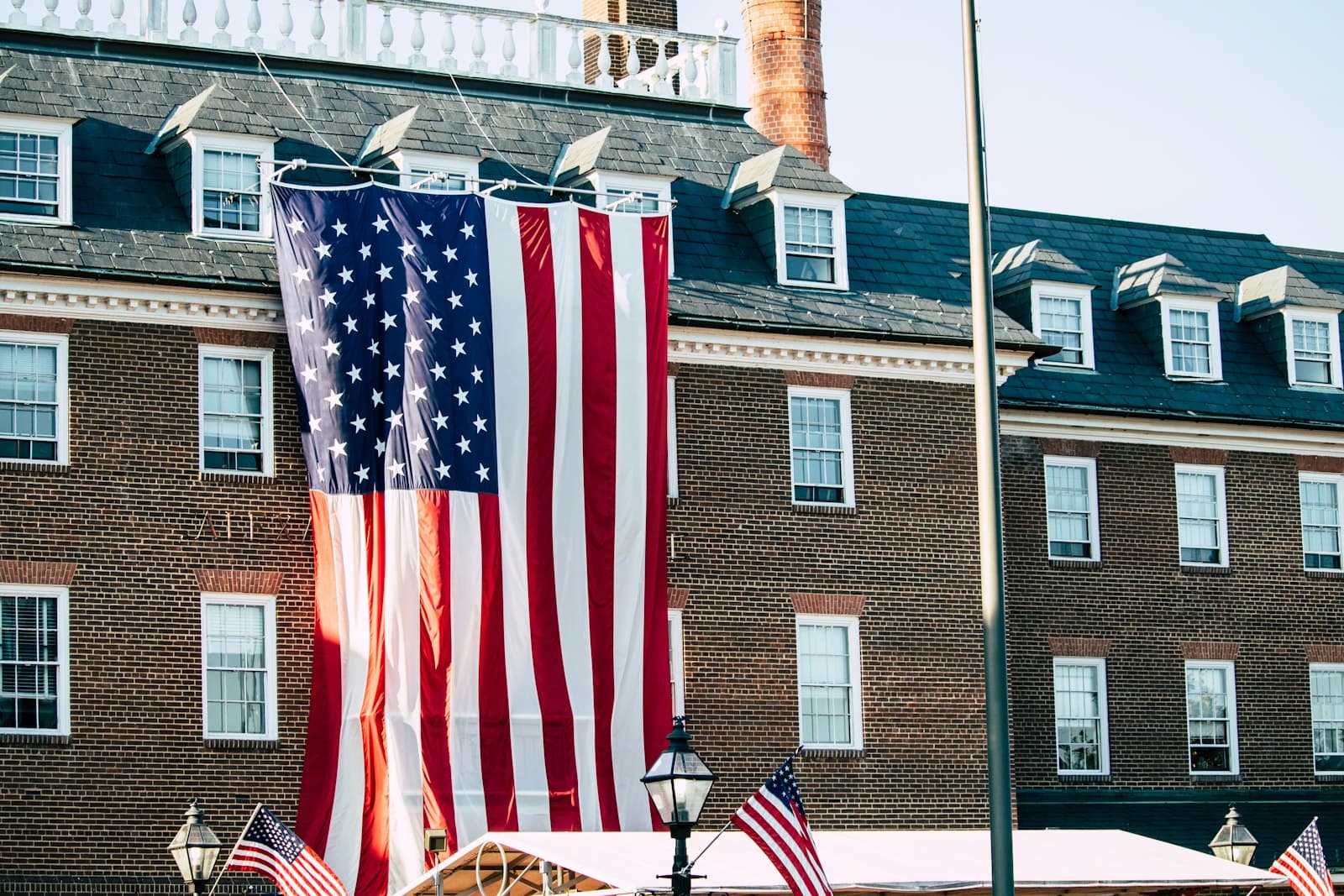 Alexandria — a large american flag hanging from the side of a building