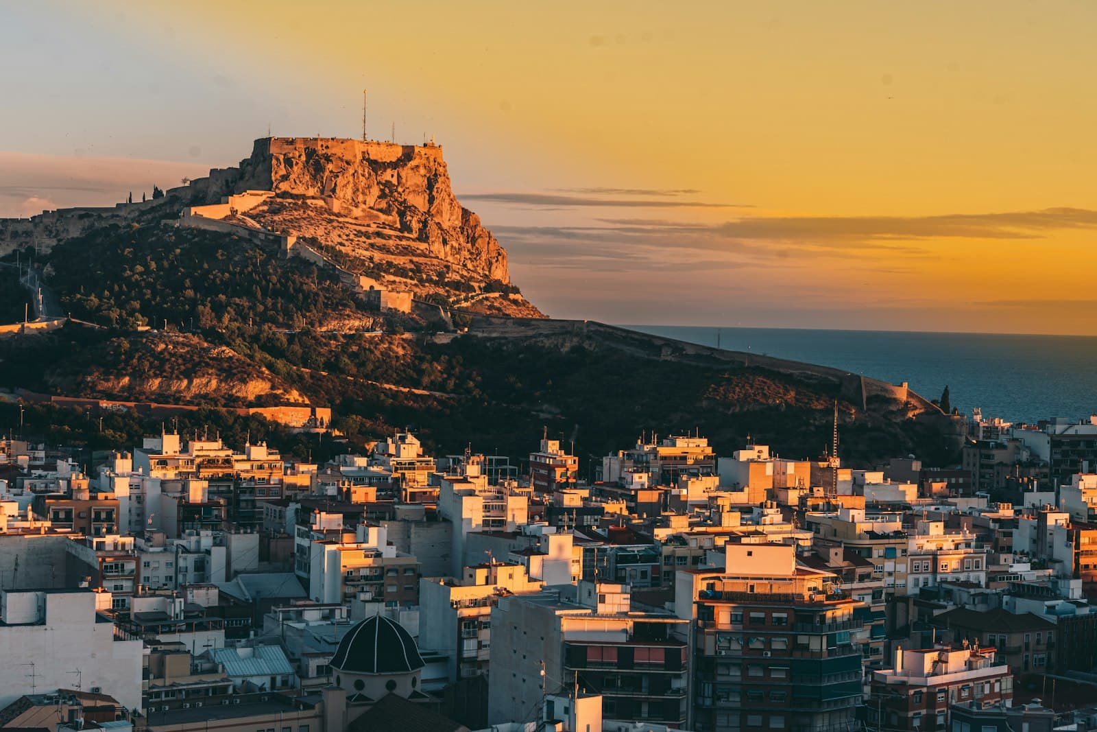Alicante — a view of a city with a mountain in the background