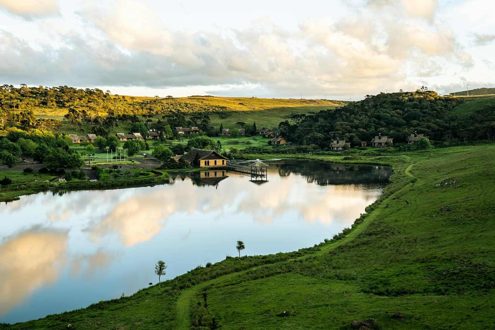 Alto Paraíso de Goiás — green grass field near lake under white clouds during daytime