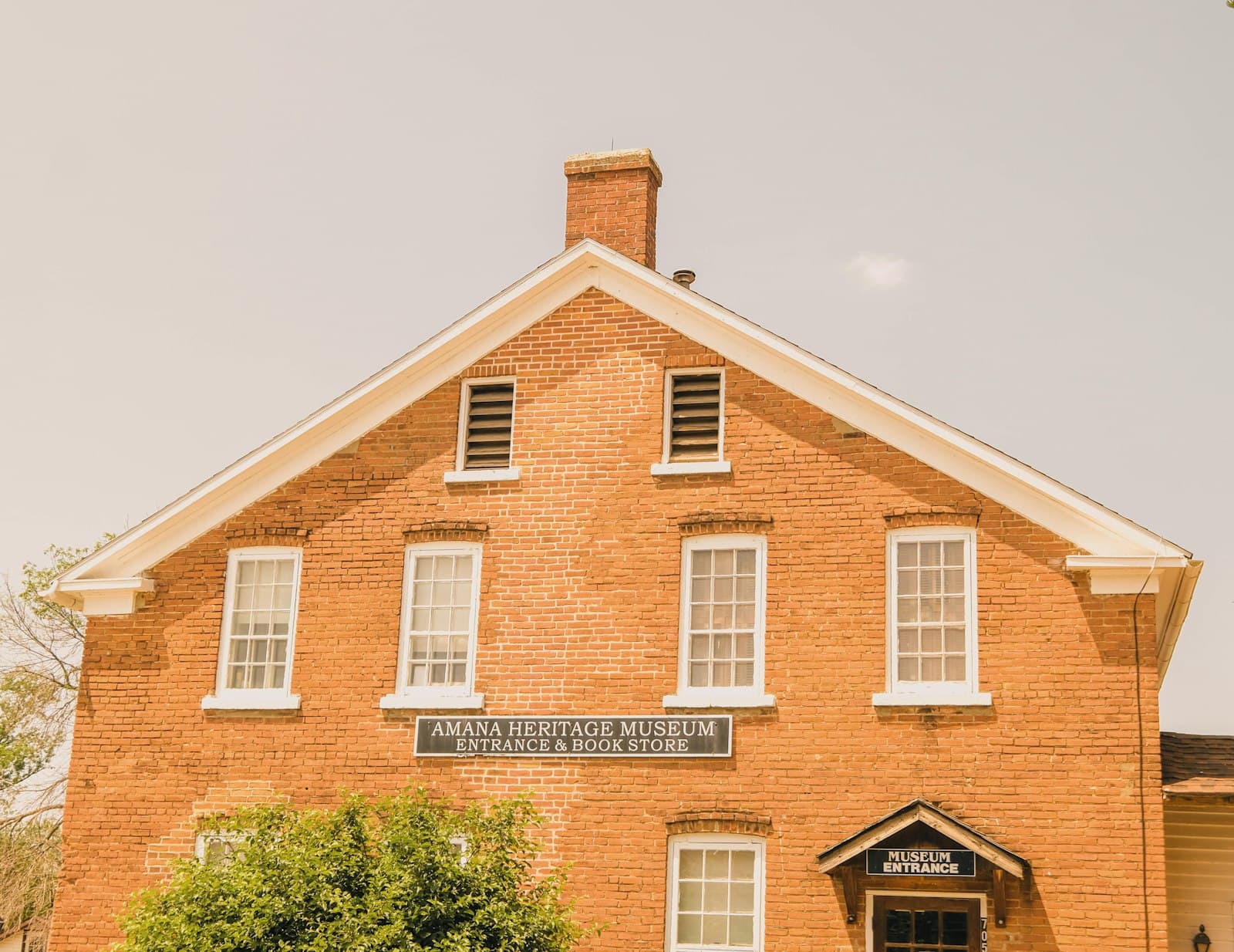 Amana — a brick building with a sign on the front of it