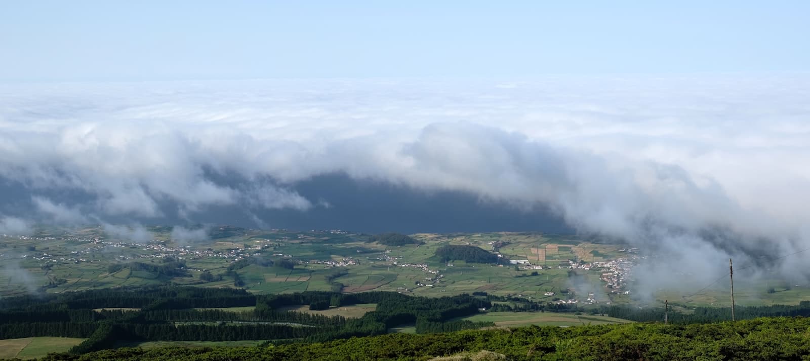 Angra do Heroísmo — green grass field under white clouds during daytime