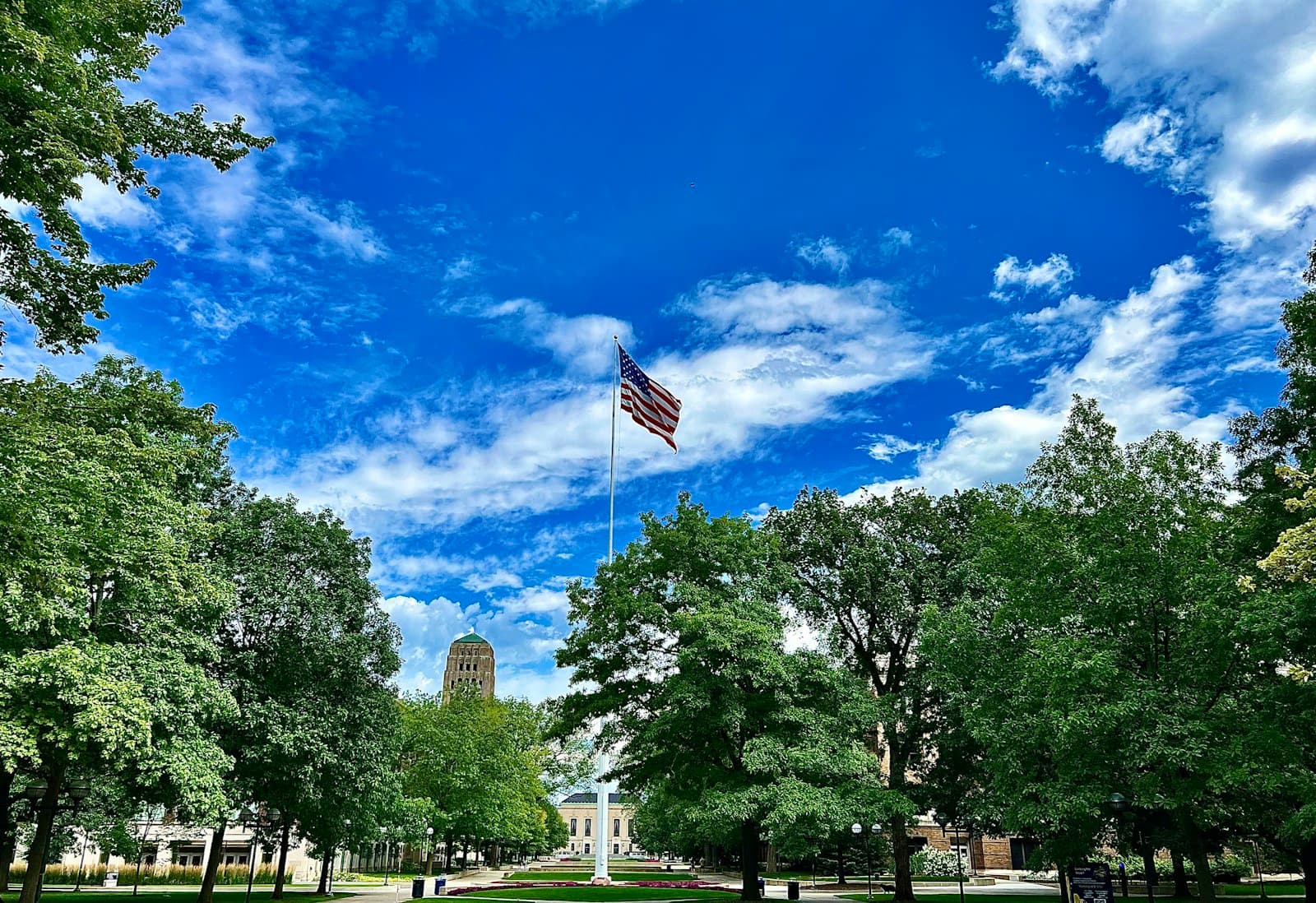 Ann Arbor — an american flag flying in the sky over a park