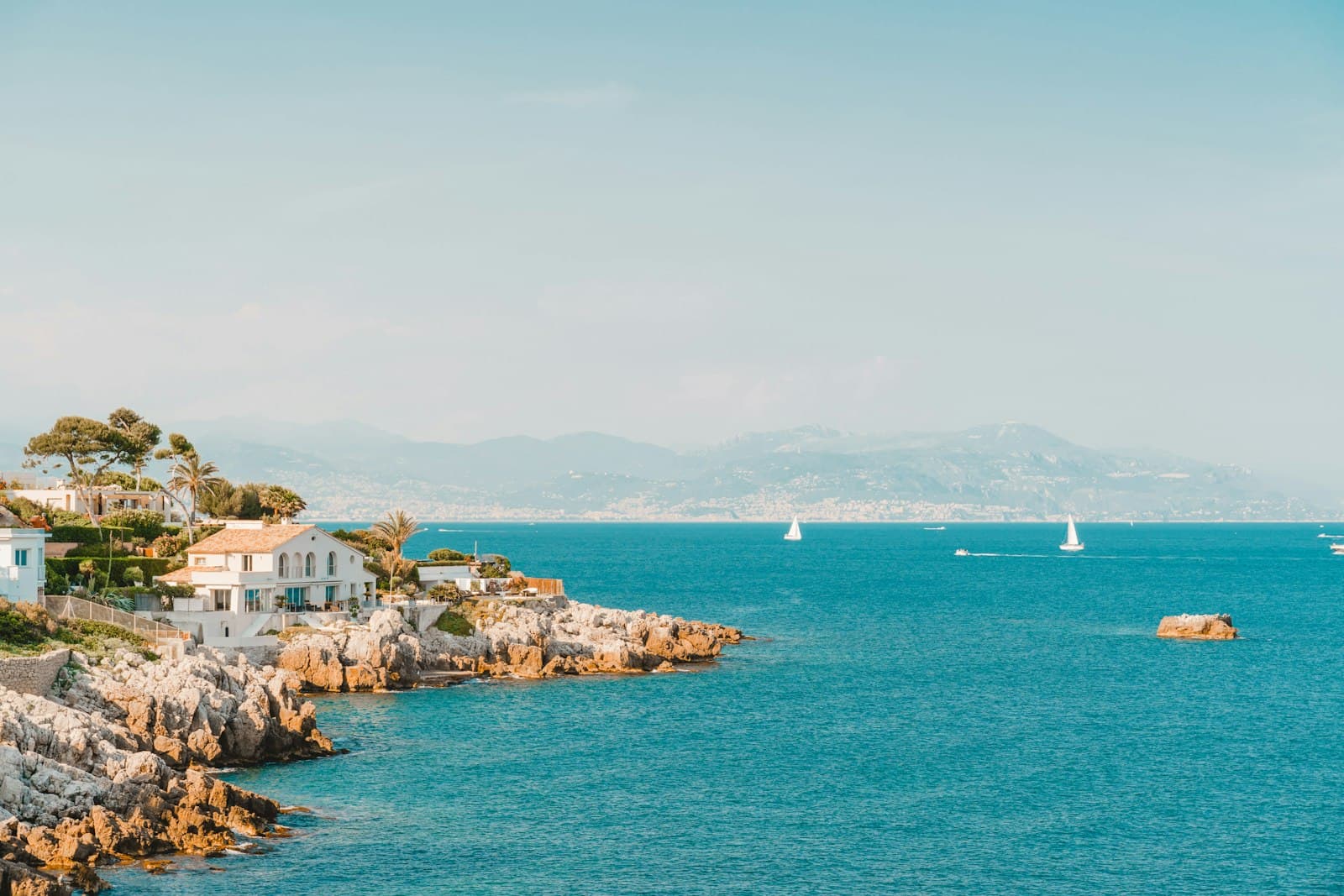 Antibes — white and brown rock formation on sea under blue sky during daytime