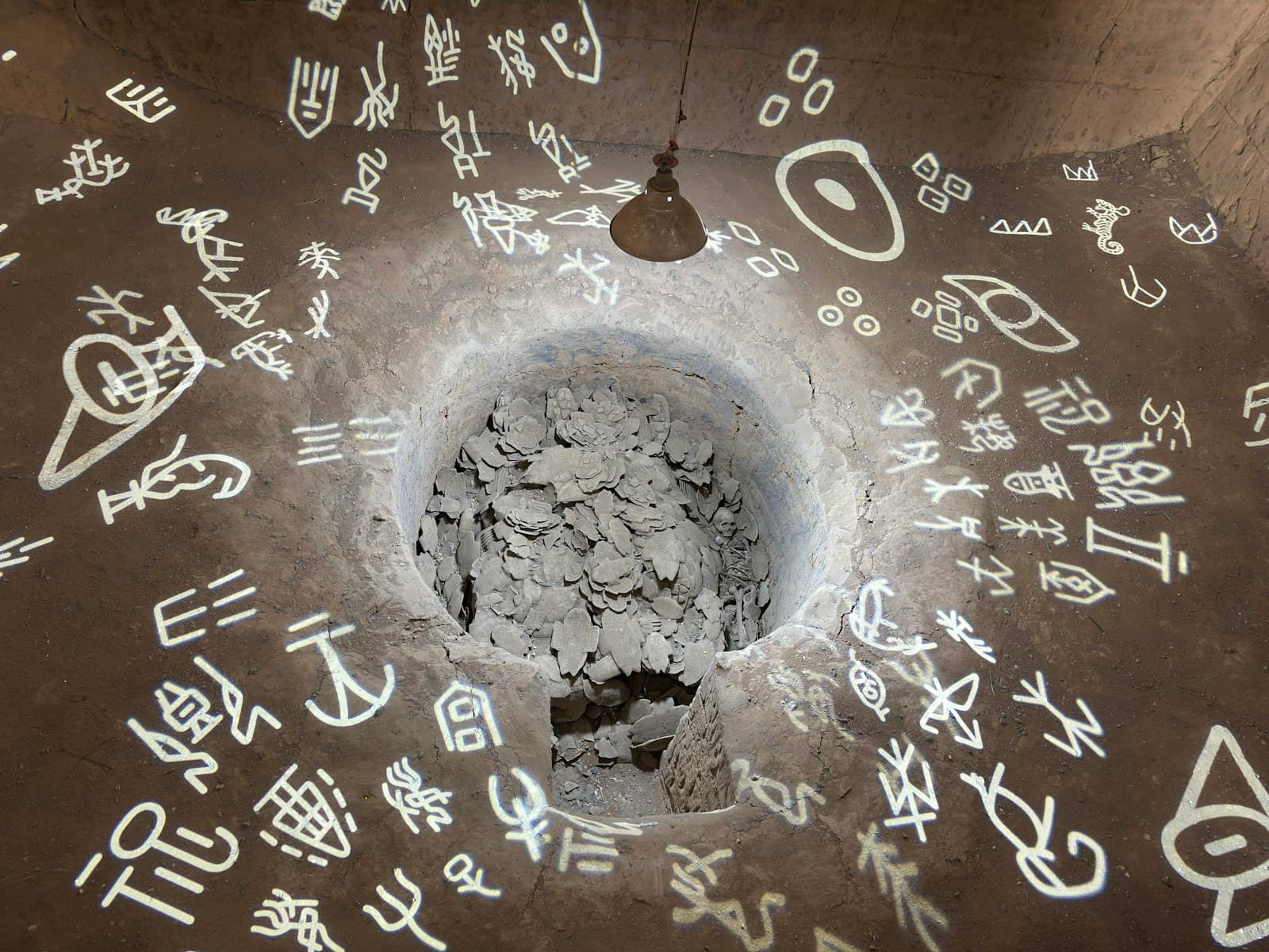 Anyang — Symbols surround a hole in the ground.