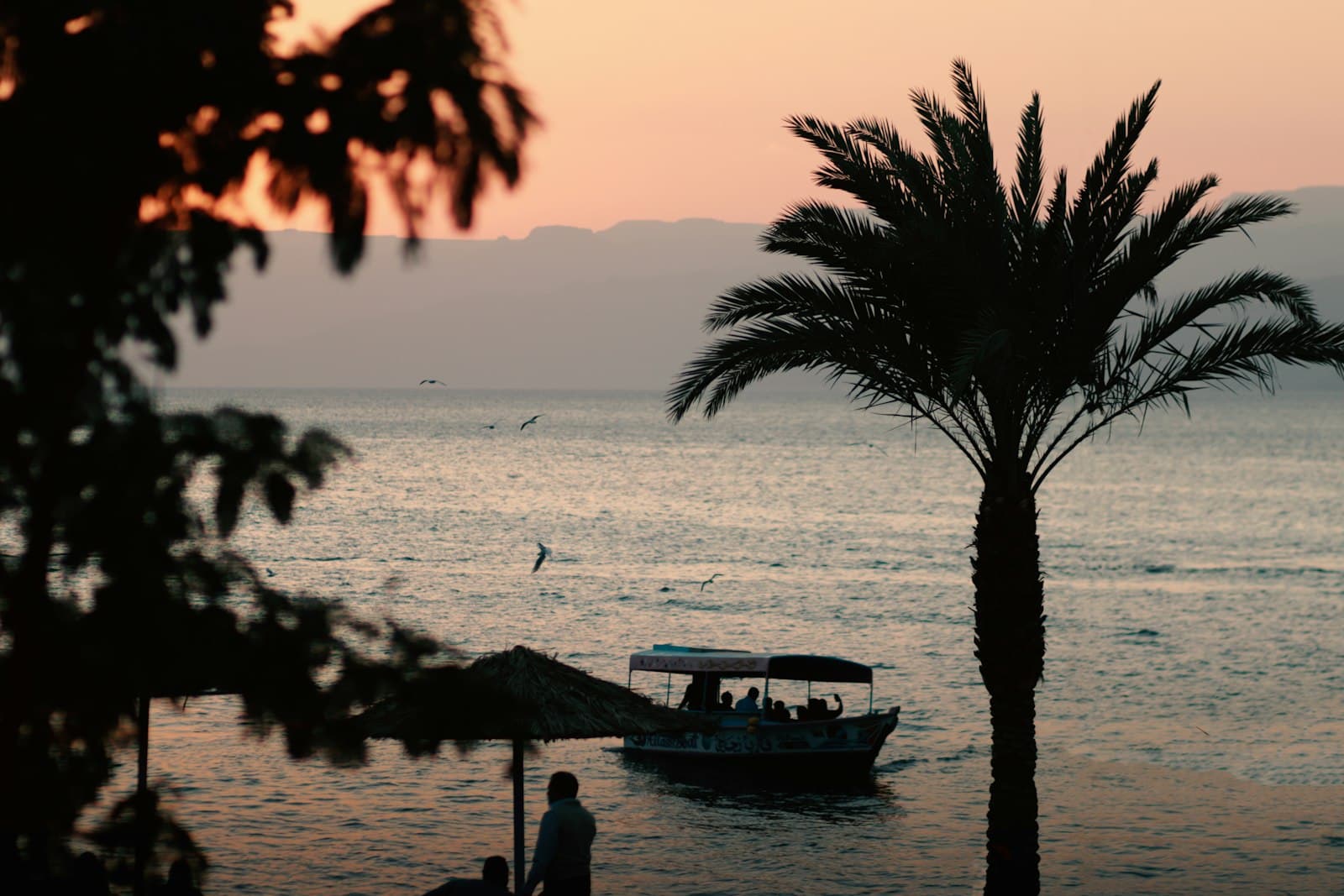 Aqaba — silhouette of people on boat on sea during sunset