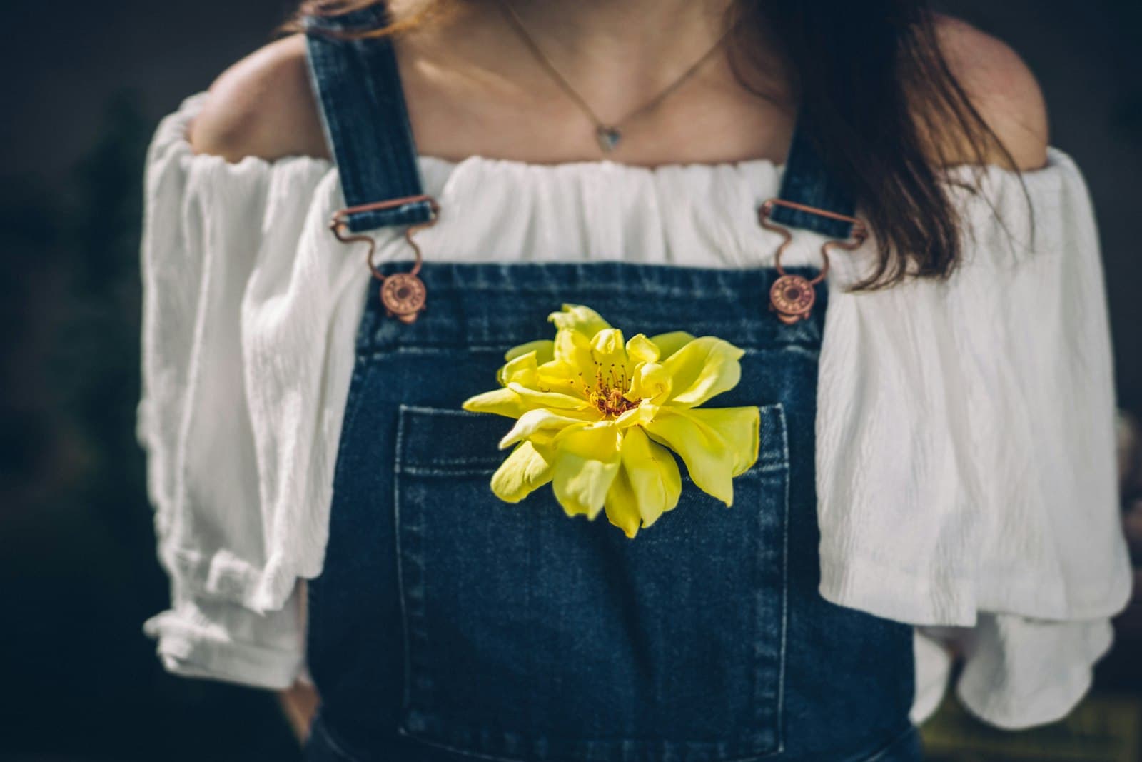 Aschaffenburg — person wearing overalls with yellow petaled flowers on pocket
