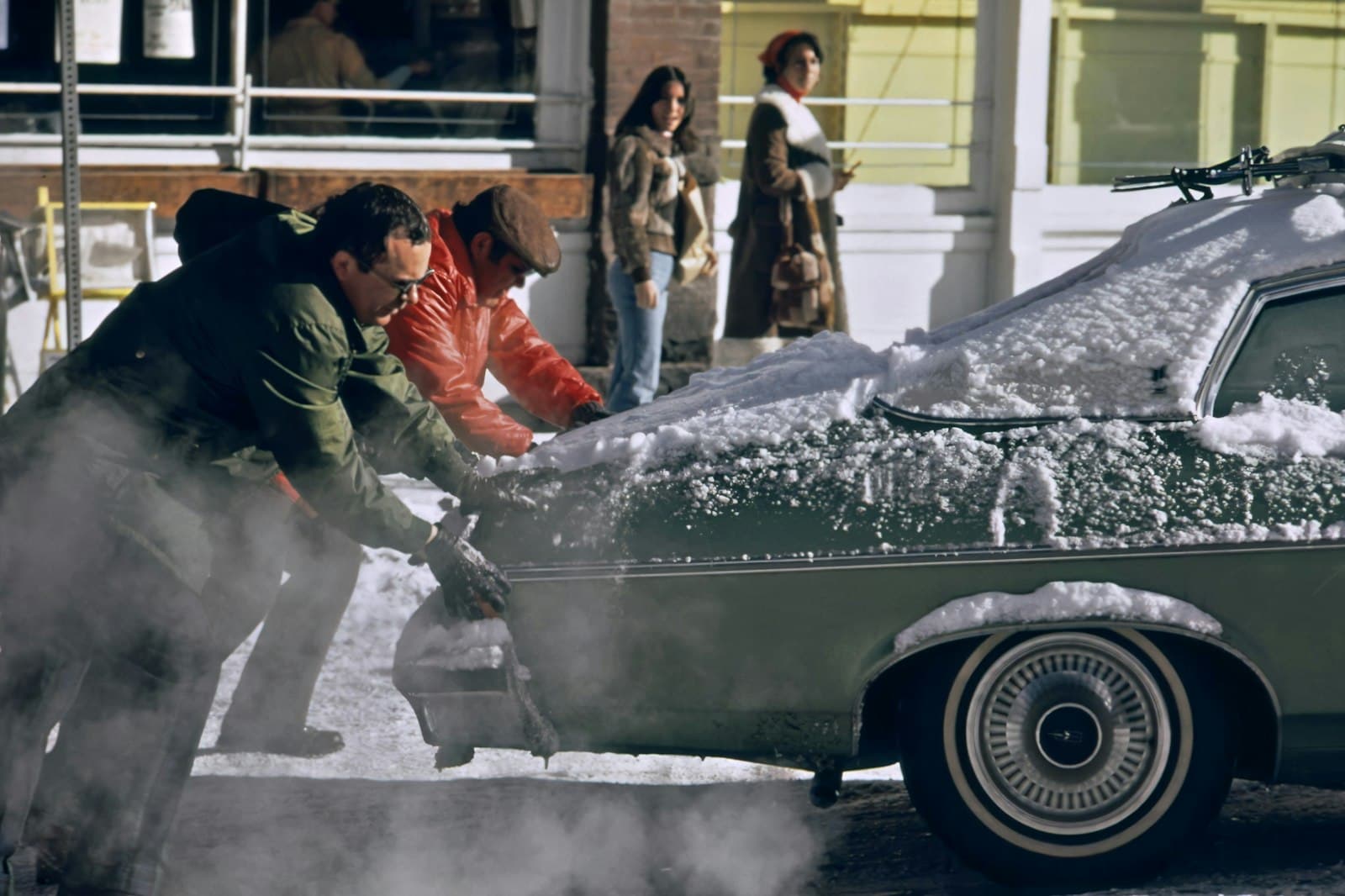 Aspen — a group of people standing around a car covered in snow