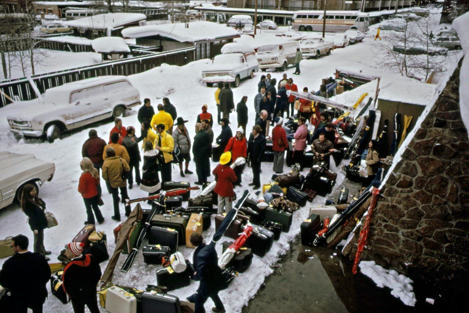 Aspen — a group of people standing around a pile of luggage