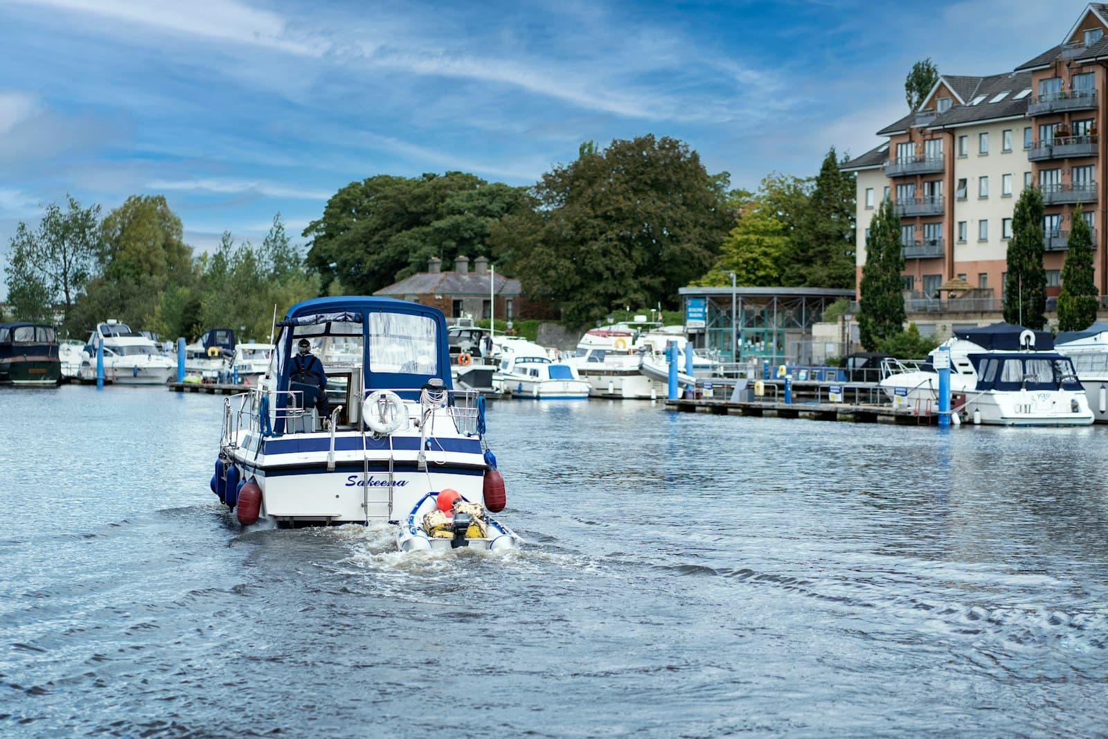 Athlone — a blue and white boat traveling down a river