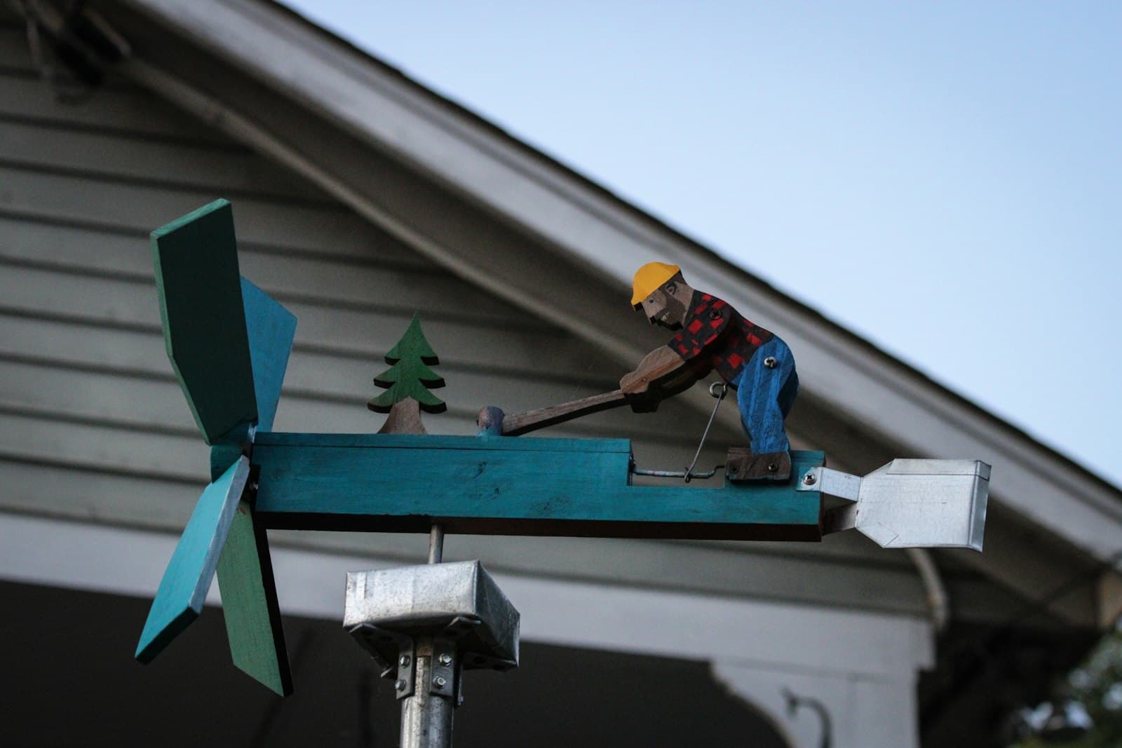 Atlanta — A man working on a wind vane on top of a house