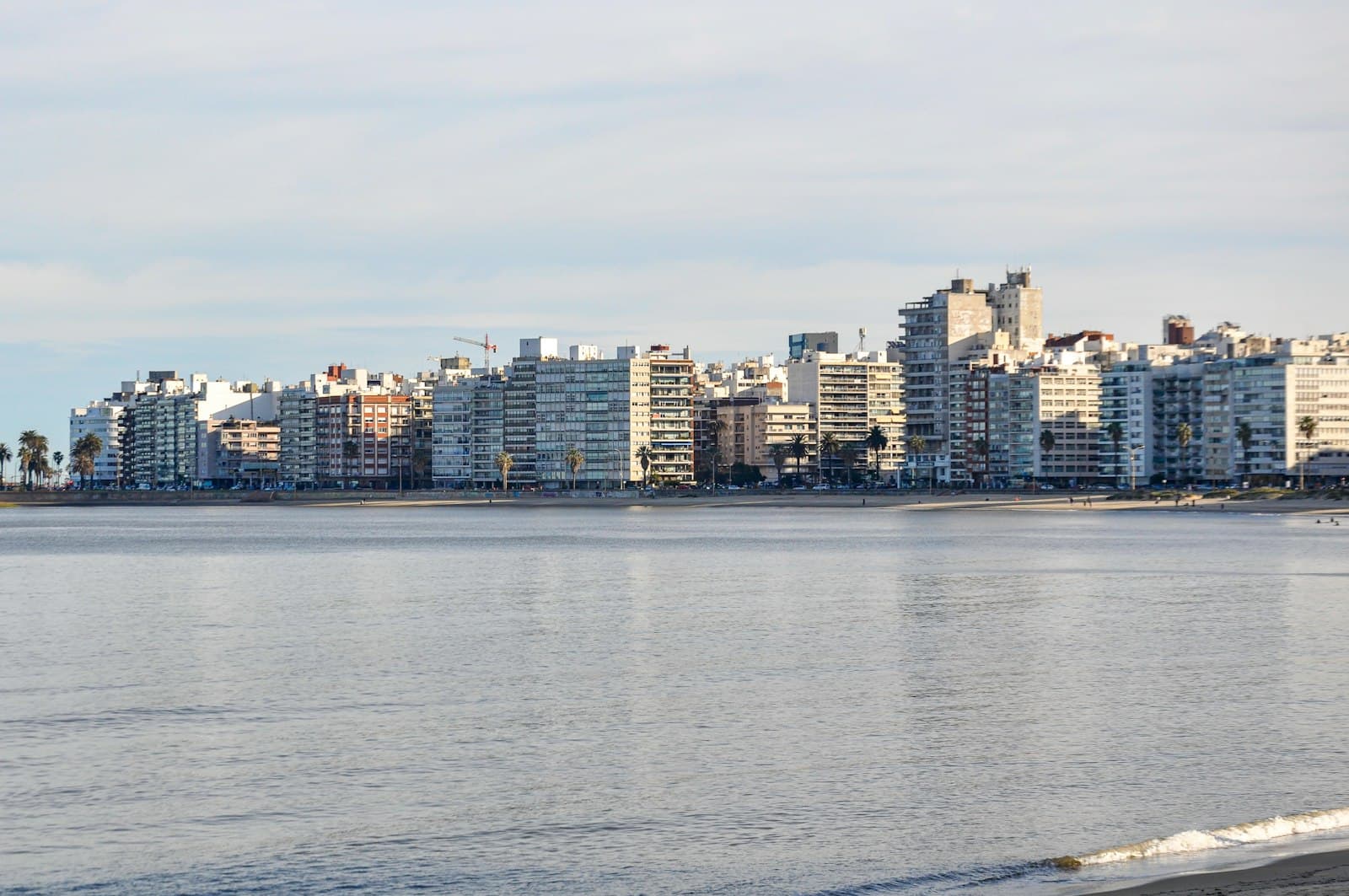 Atlántida — City skyline with tall buildings reflected in the calm water.
