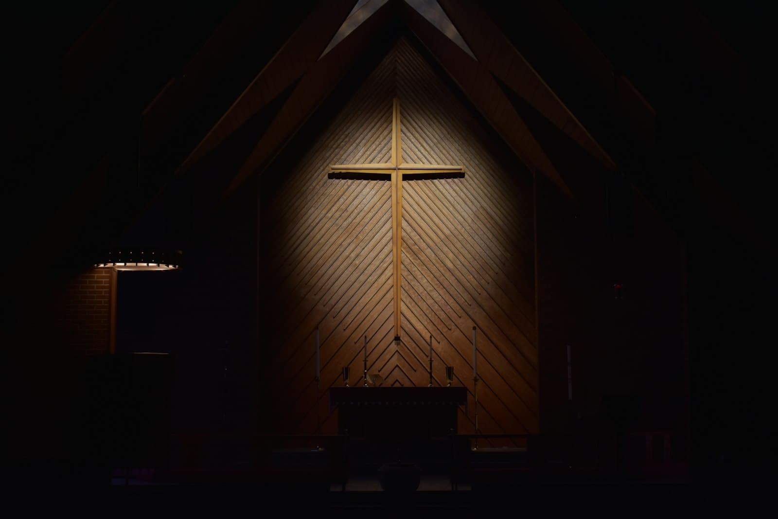 Augusta — brown wooden cross on brown wooden wall