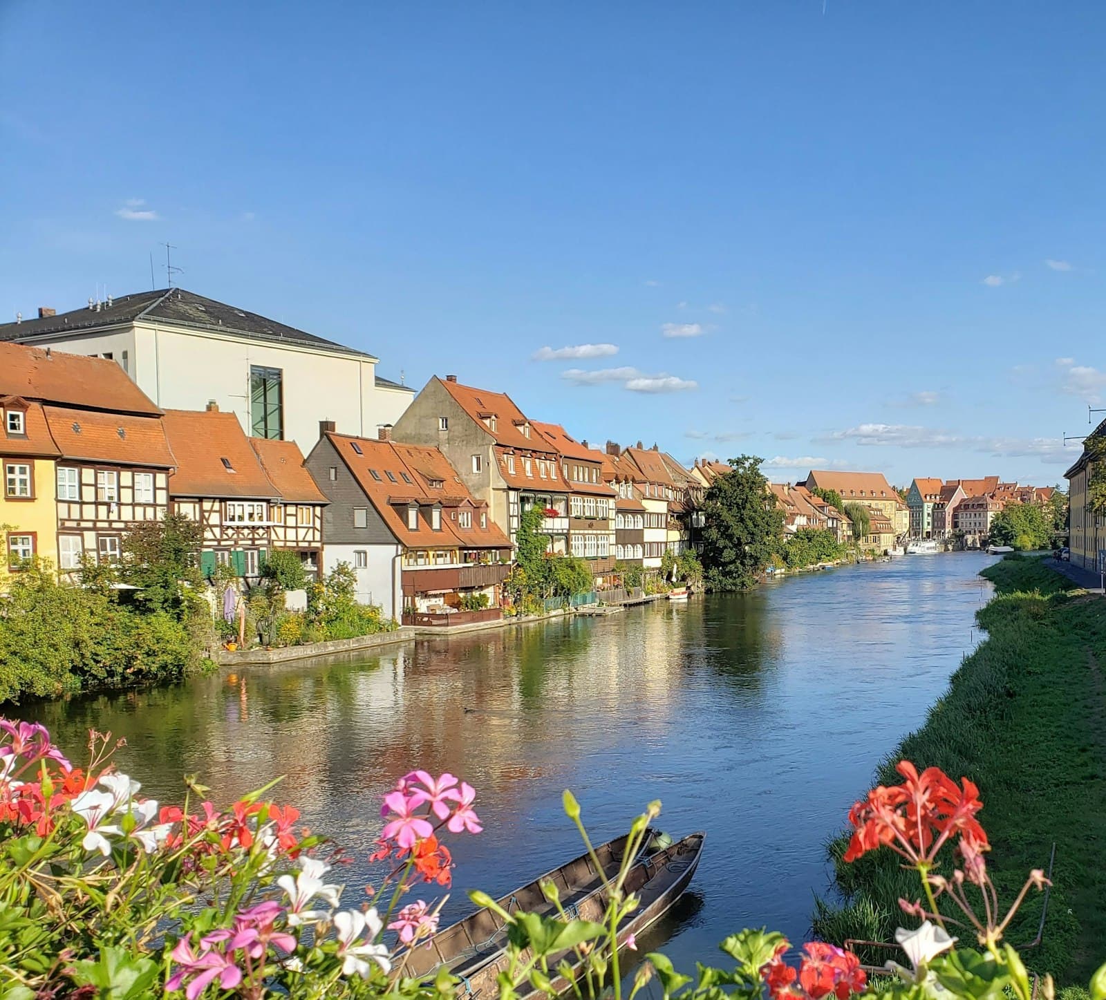 Bad Doberan — brown and white concrete houses beside river under blue sky during daytime