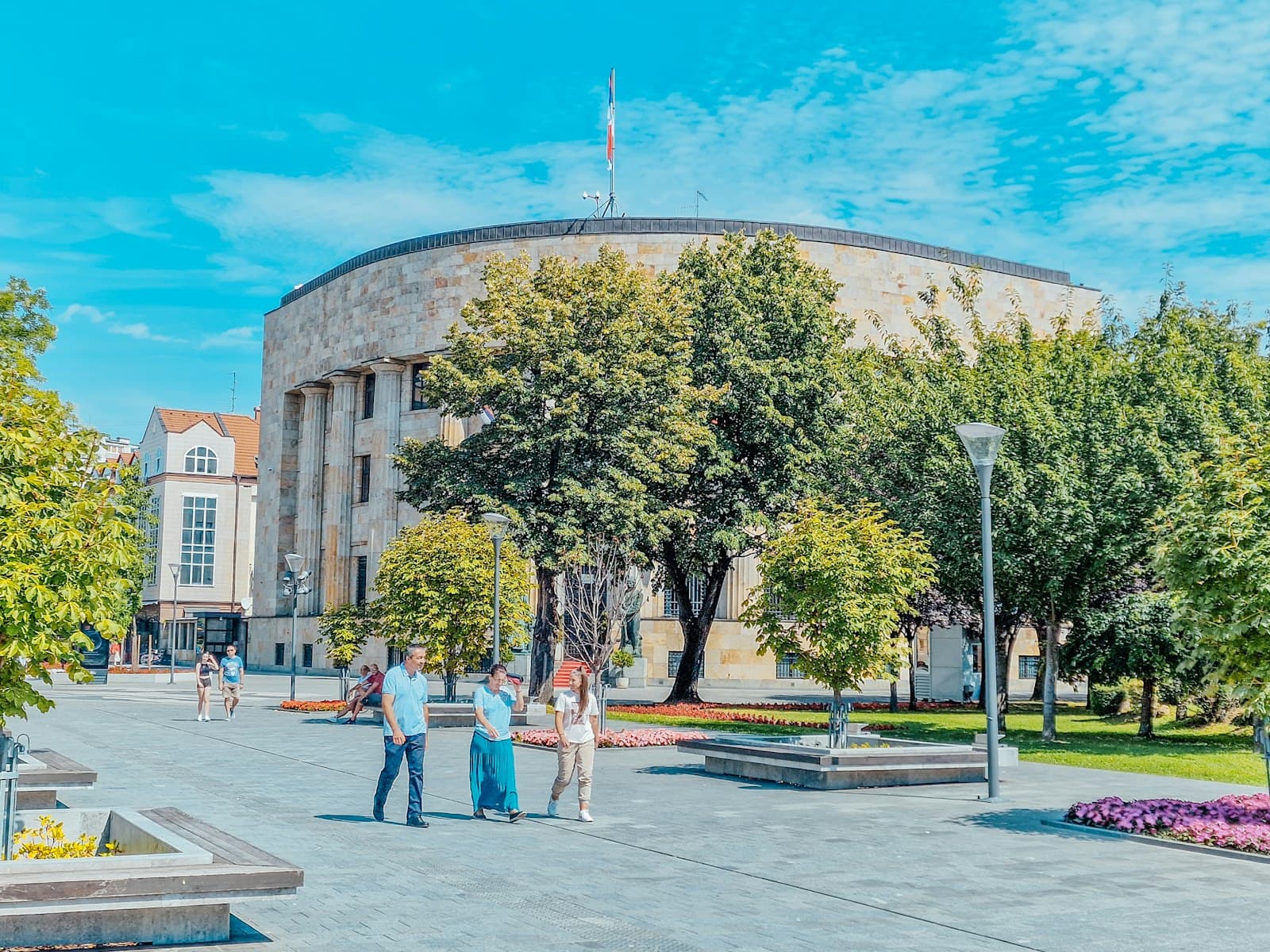 Banja Luka — a group of people walking around a large building