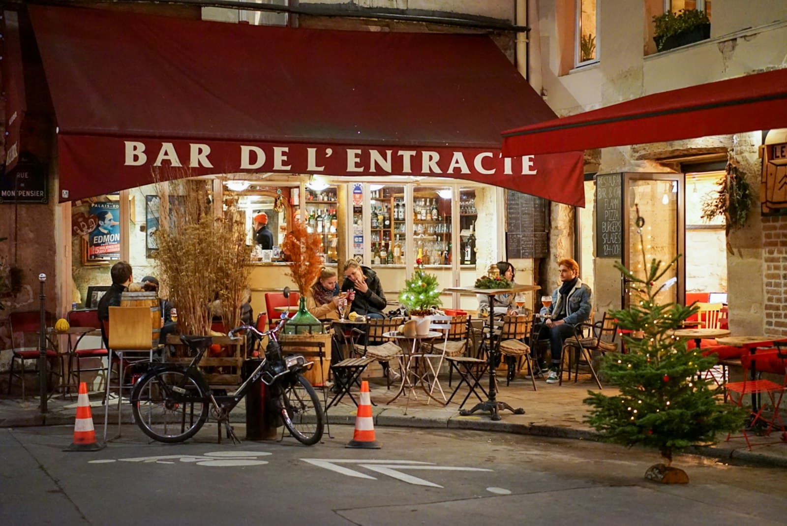Bar-le-Duc — a group of people sitting at tables outside of a restaurant