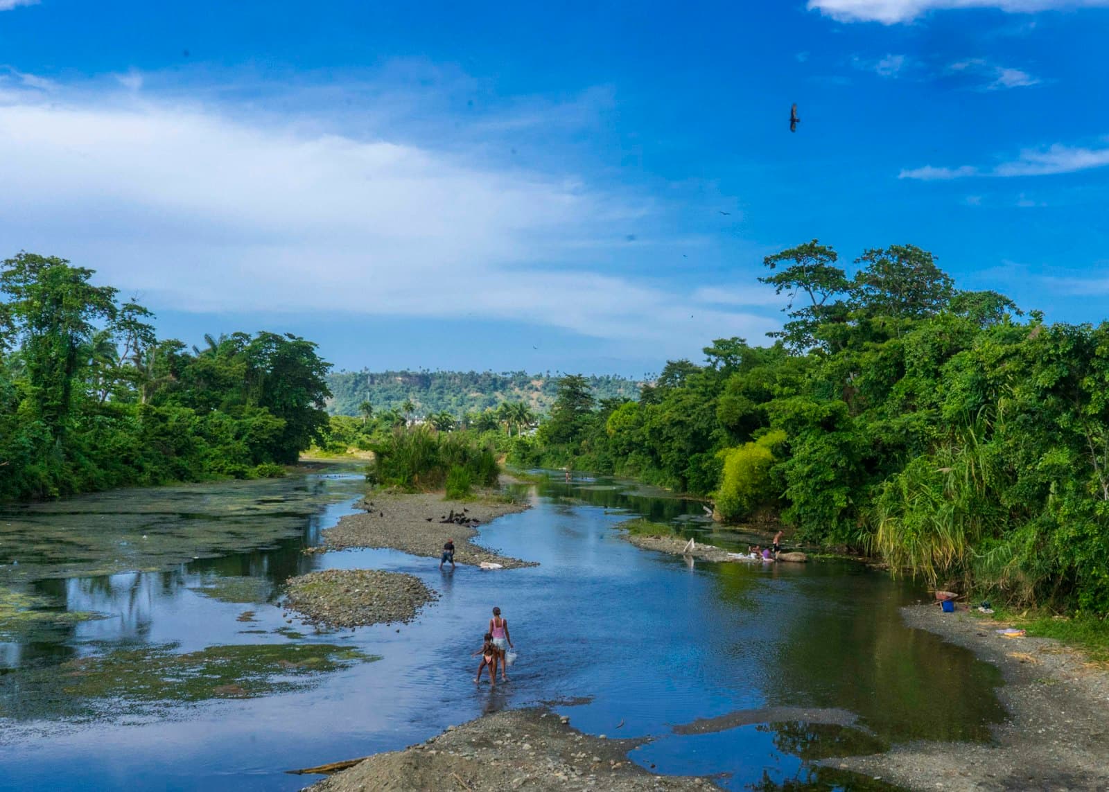 Baracoa — A man standing on the edge of a river