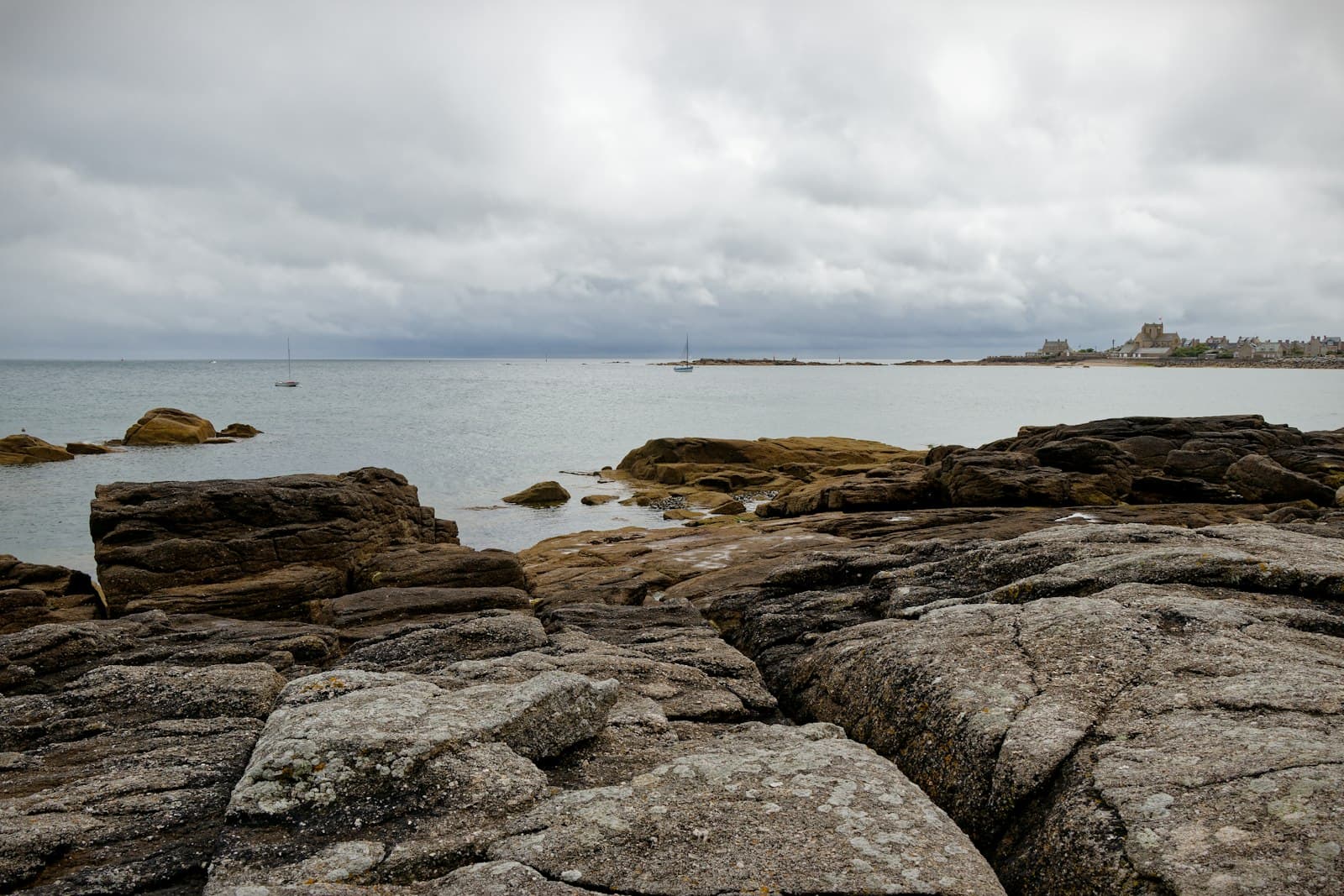 Barfleur — A rocky beach with a body of water in the background