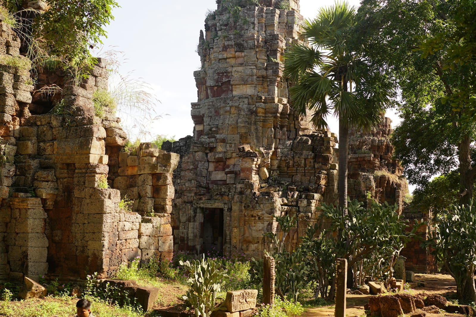 Battambang — a stone building with trees and plants