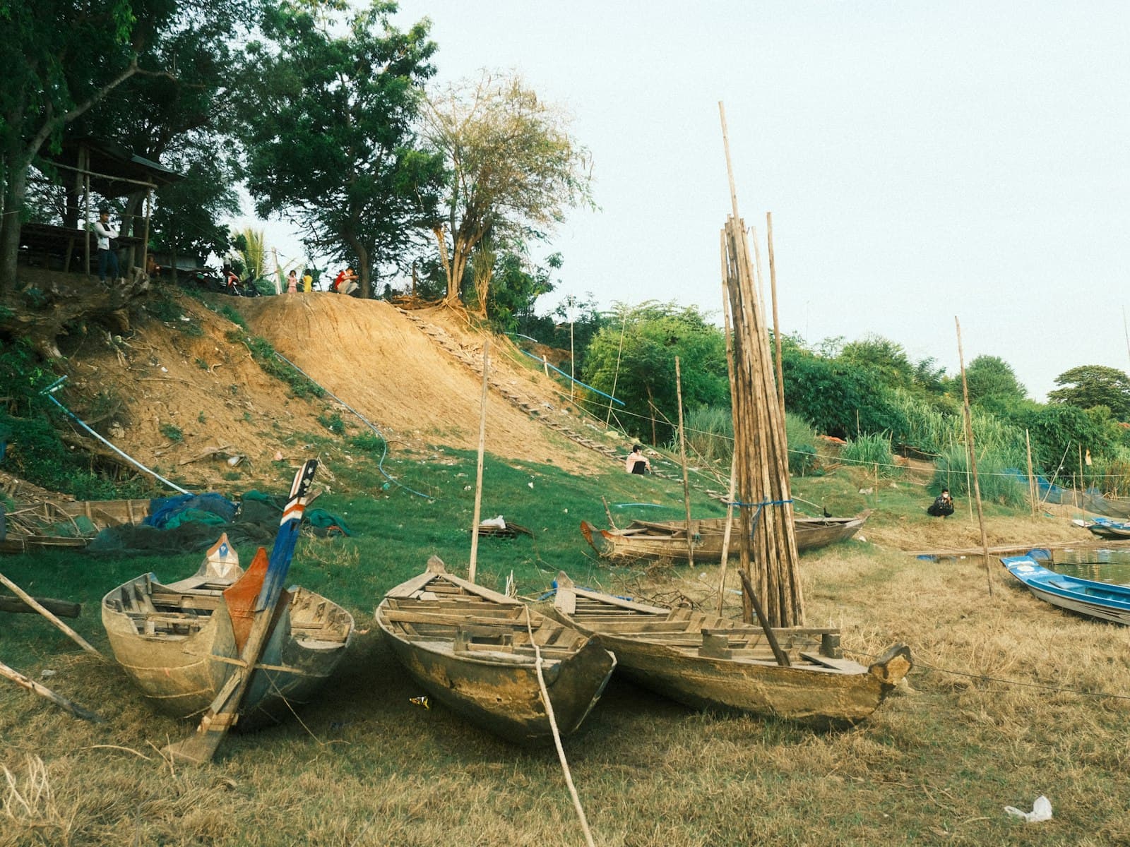 Battambang — a group of boats sitting on top of a grass covered field