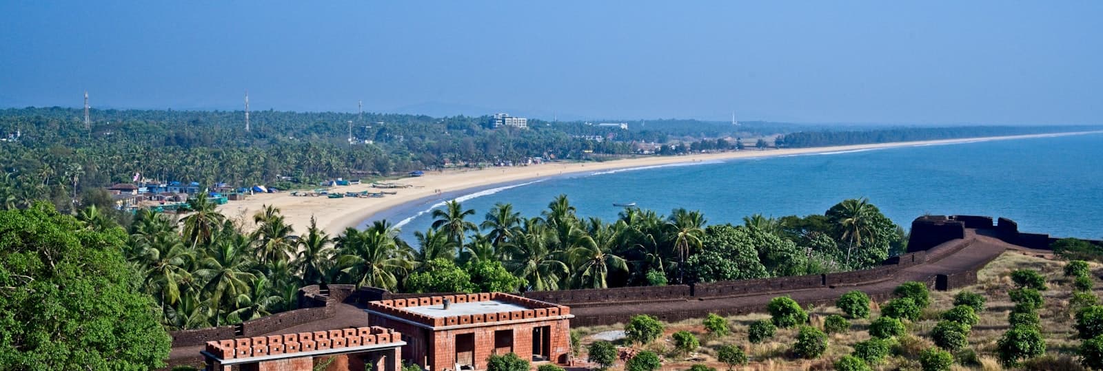 Bekal — brown concrete building near body of water during daytime