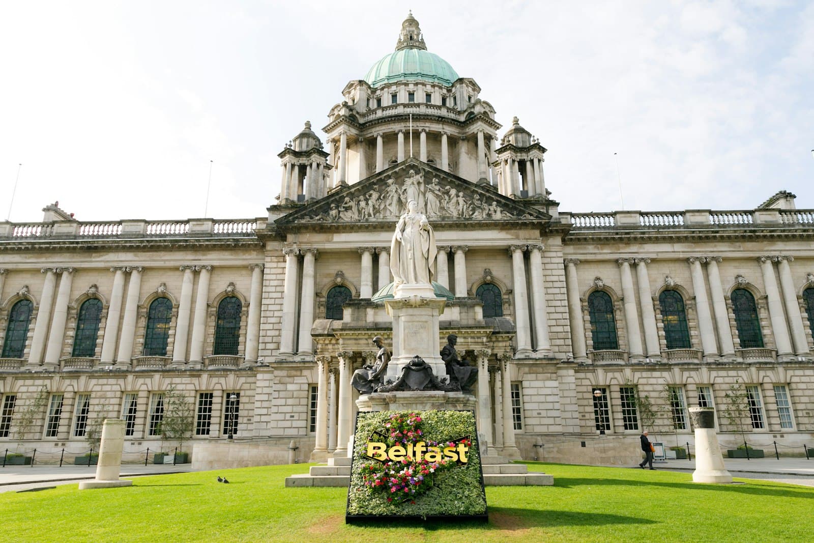 Belfast — white concrete building with green grass lawn