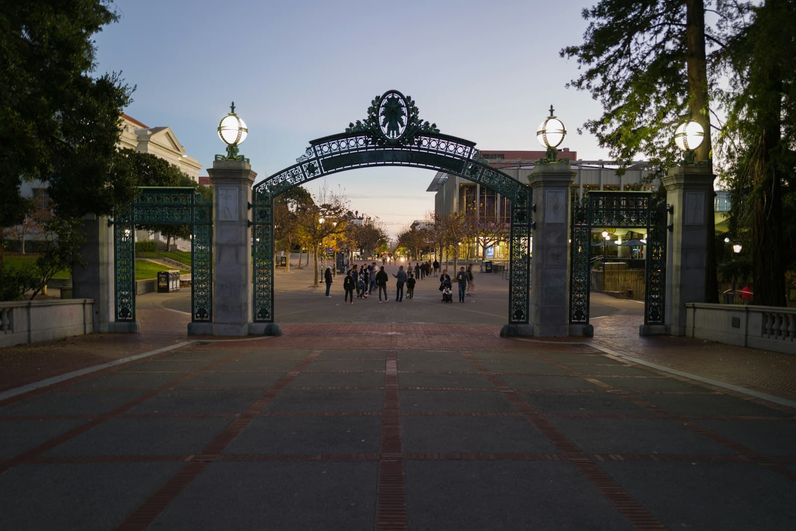 Berkeley — a group of people walking down a street under an arch