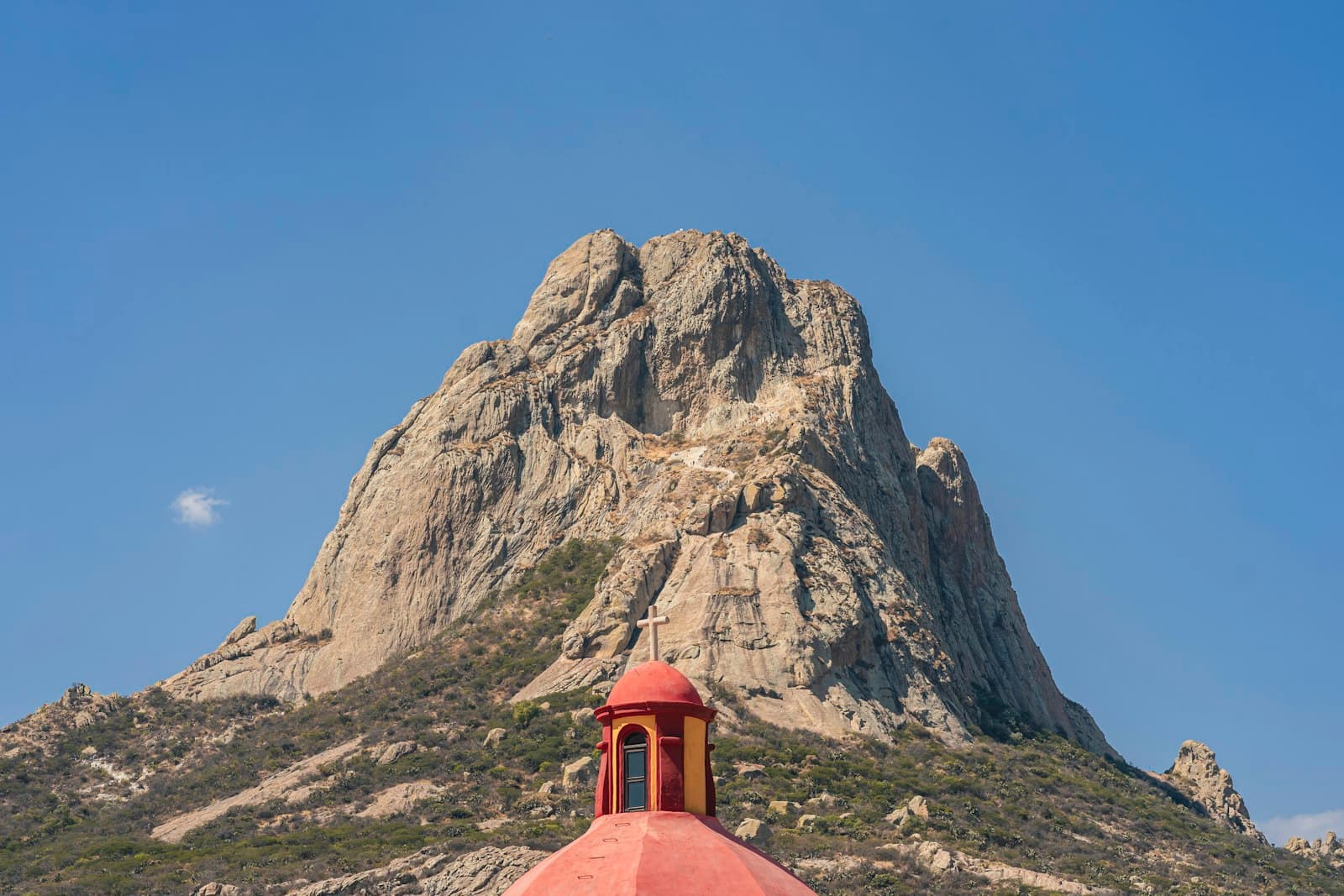Bernal — a red dome on top of a building in front of a mountain