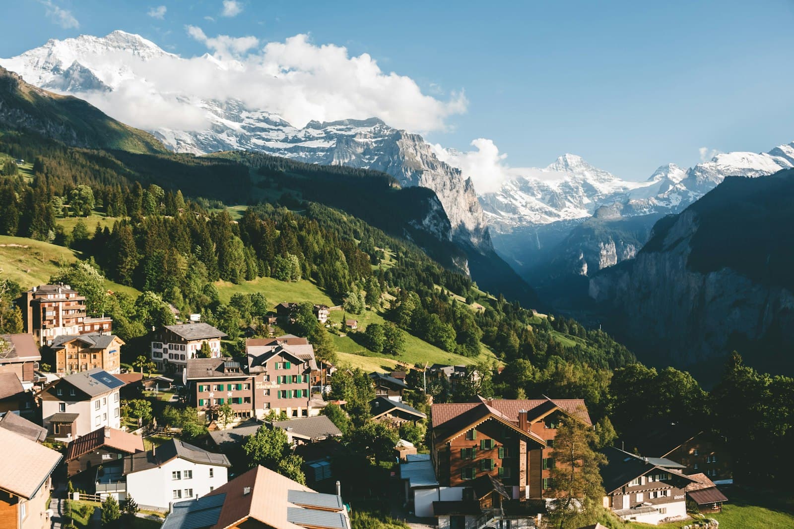 Bern — brown and white houses on green mountain under blue sky during daytime