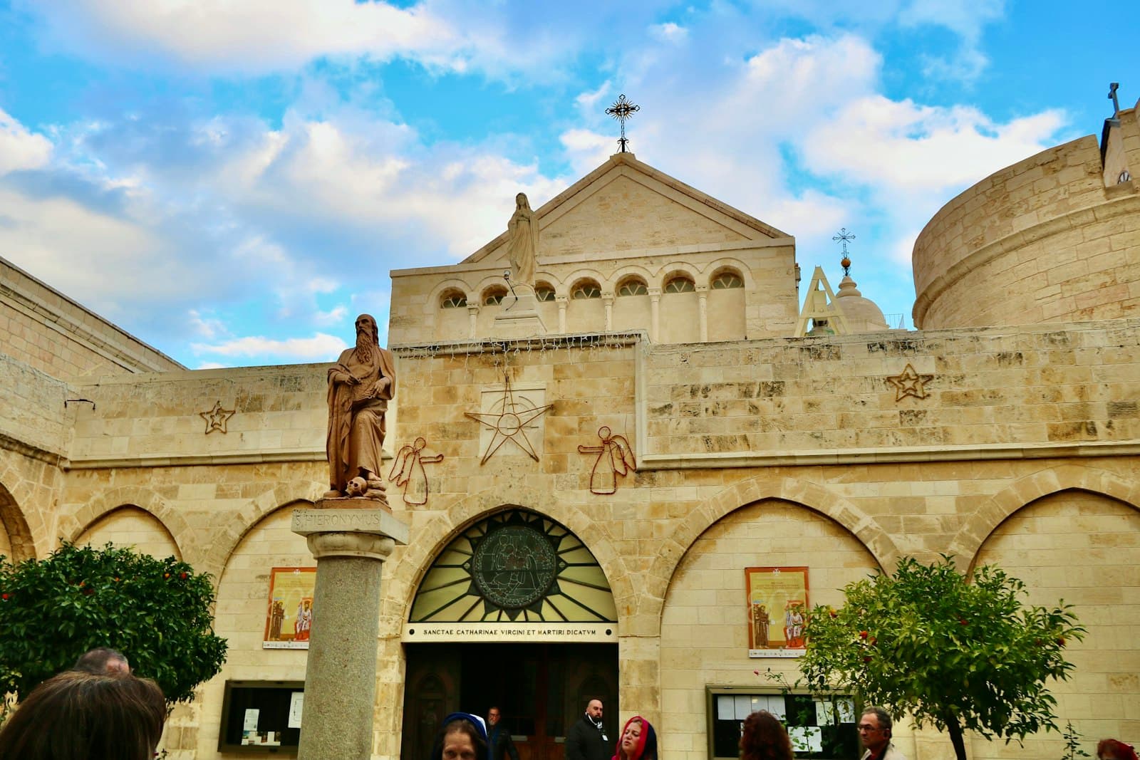 Bethlehem — people walking near brown concrete building during daytime