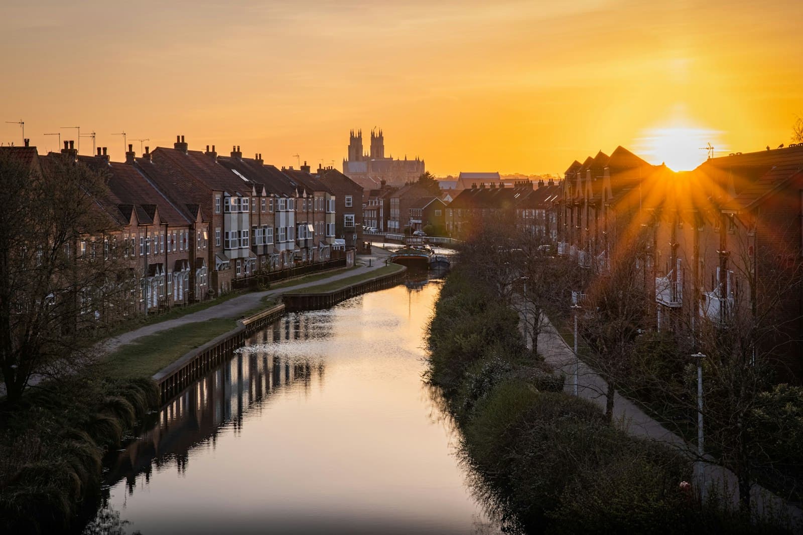 Beverley — body of water between houses during sunset