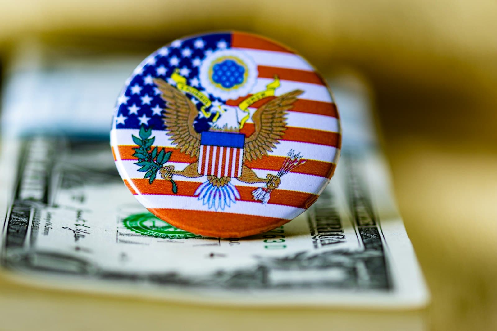 Bird-in-Hand — A close up of a button on a dollar bill