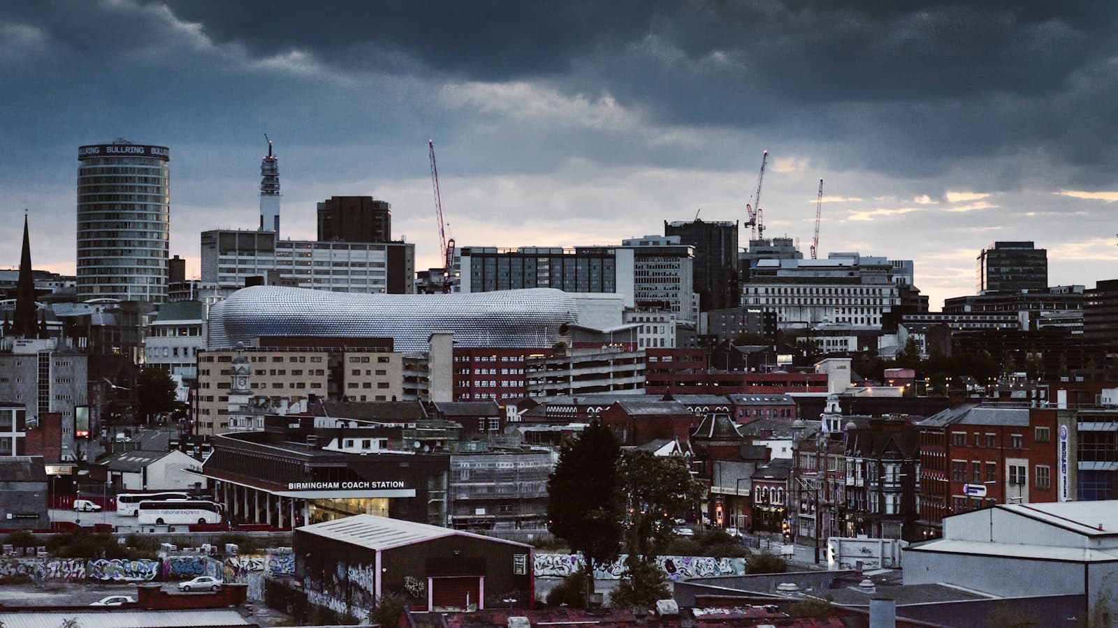 Birmingham — concrete building and houses under gray sky