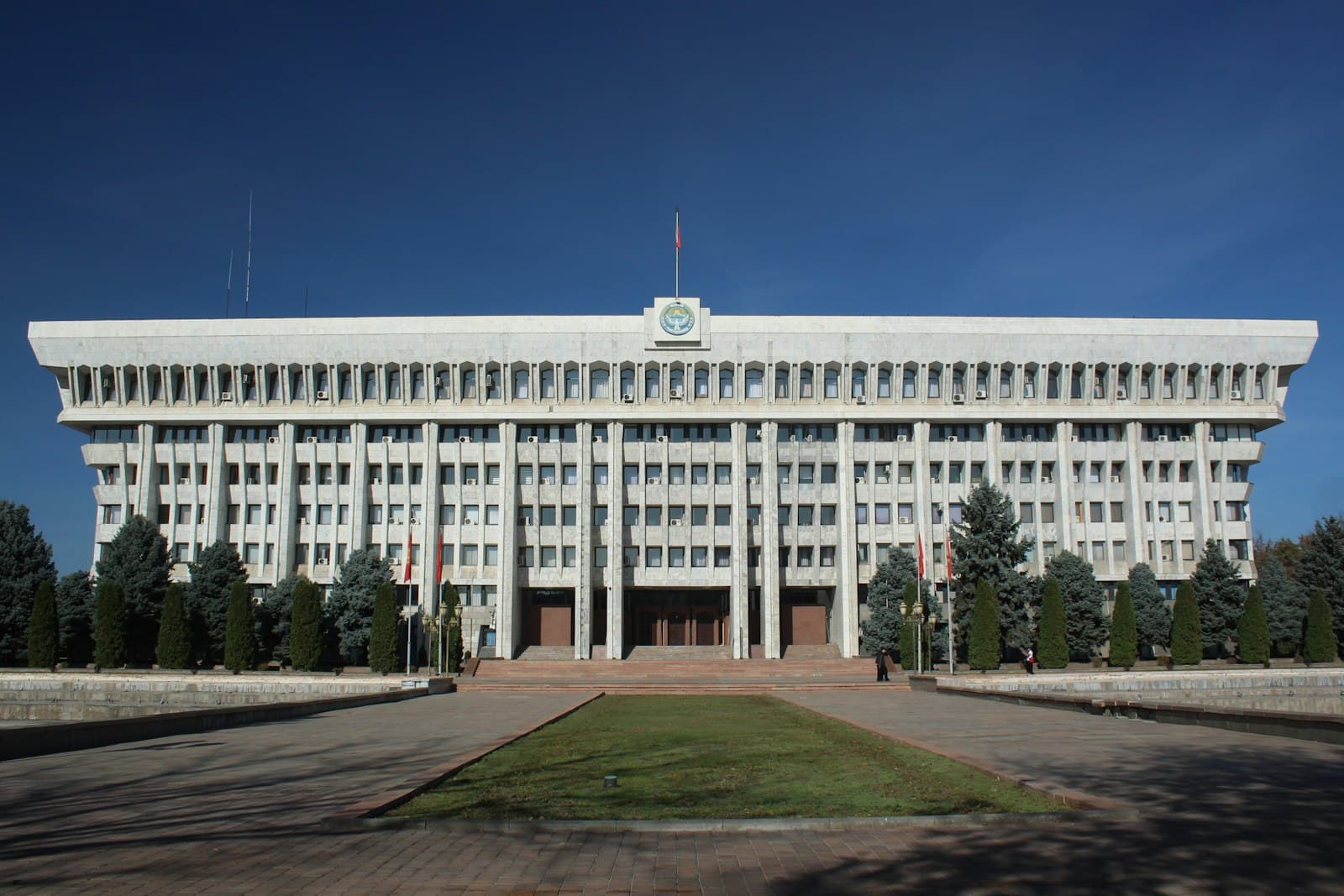 Bishkek — a large white building with a clock on top of it