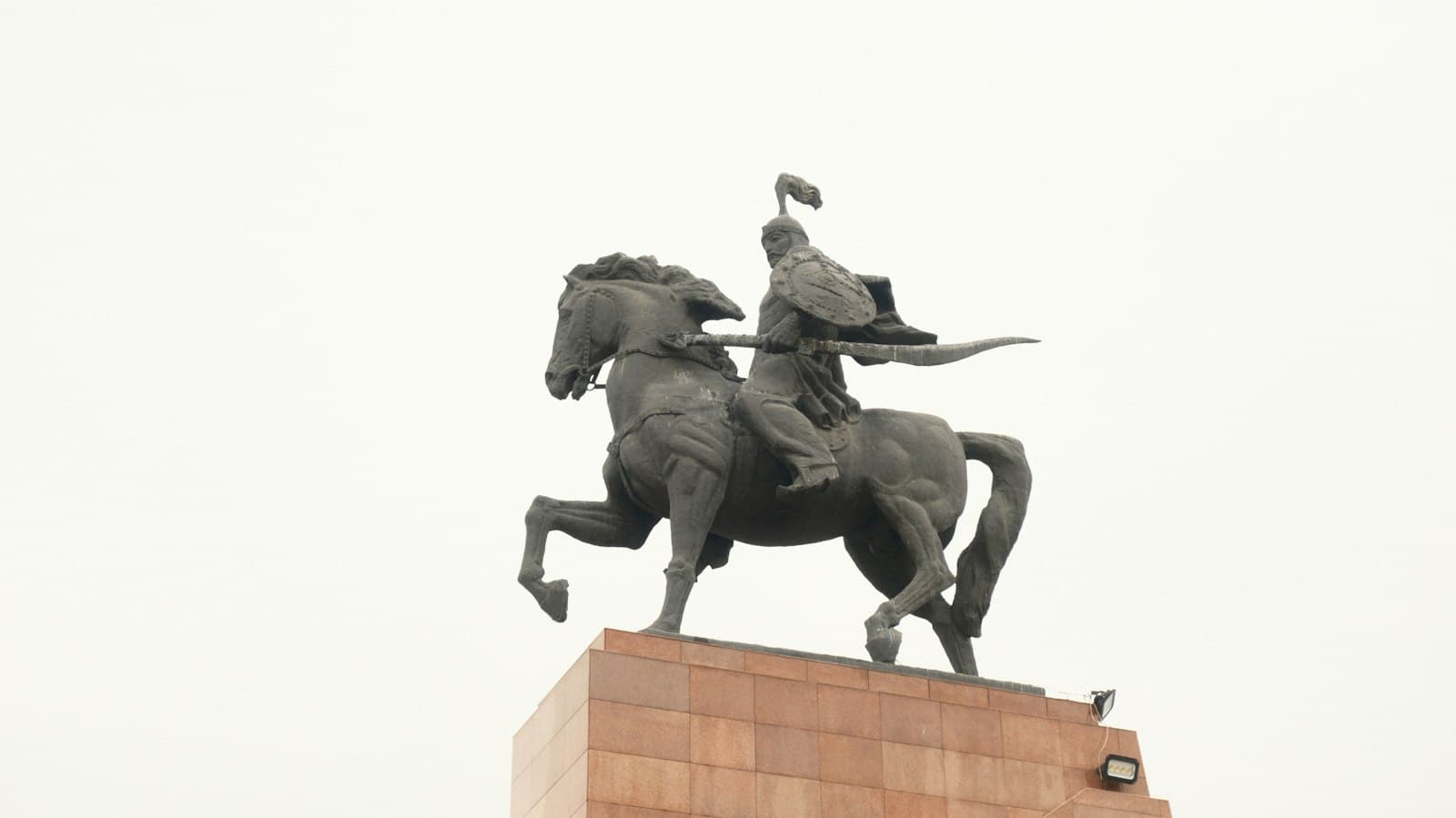 Bishkek — A statue of a man on a horse on top of a building