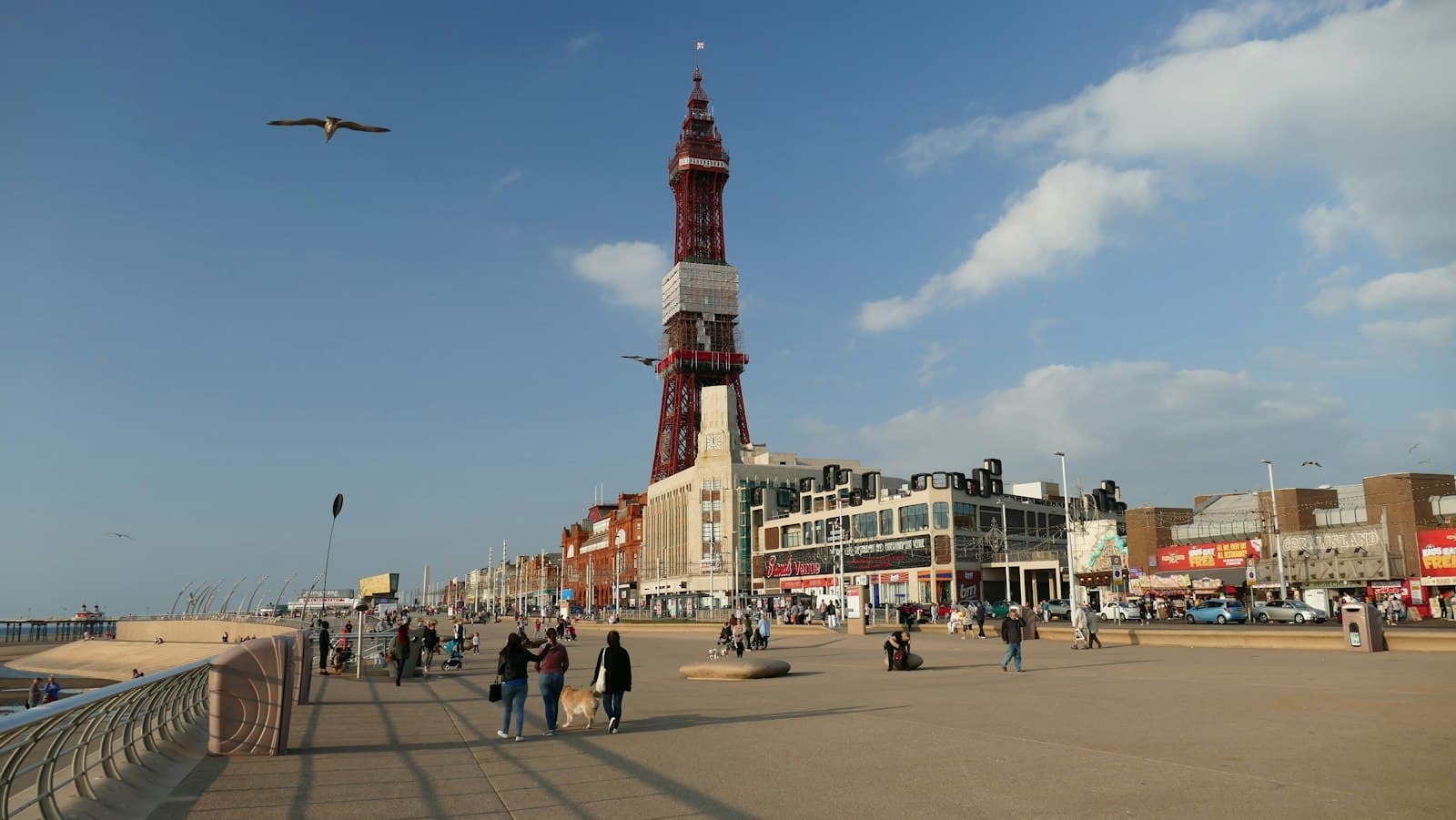 Blackpool — people walking on street near red and white tower during daytime