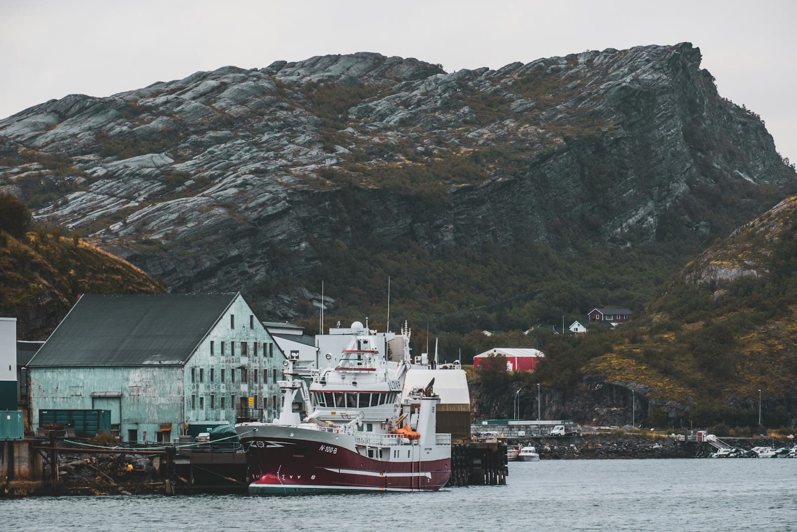 Bodø — a large boat in a body of water near a mountain