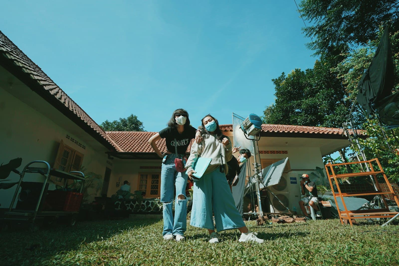 Bogor — woman in black and white long sleeve shirt standing on green grass field during daytime