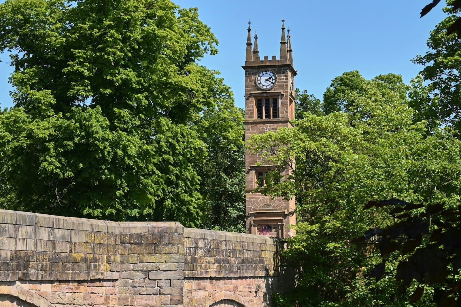 Bolton — a stone wall with a clock tower in the background