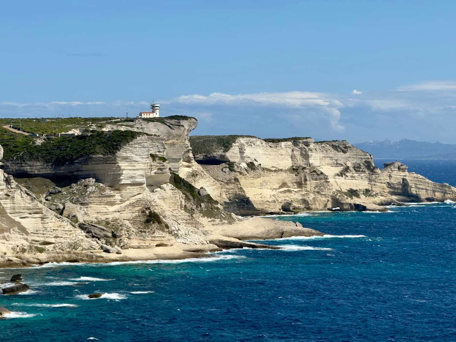 Bonifacio — A view of a rocky coastline with a lighthouse on top of it