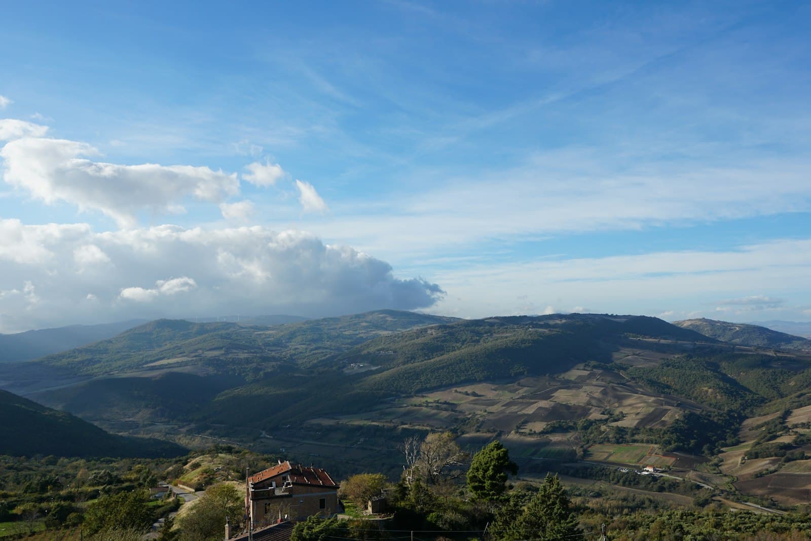Bovino — a view of a mountain range with a house in the foreground