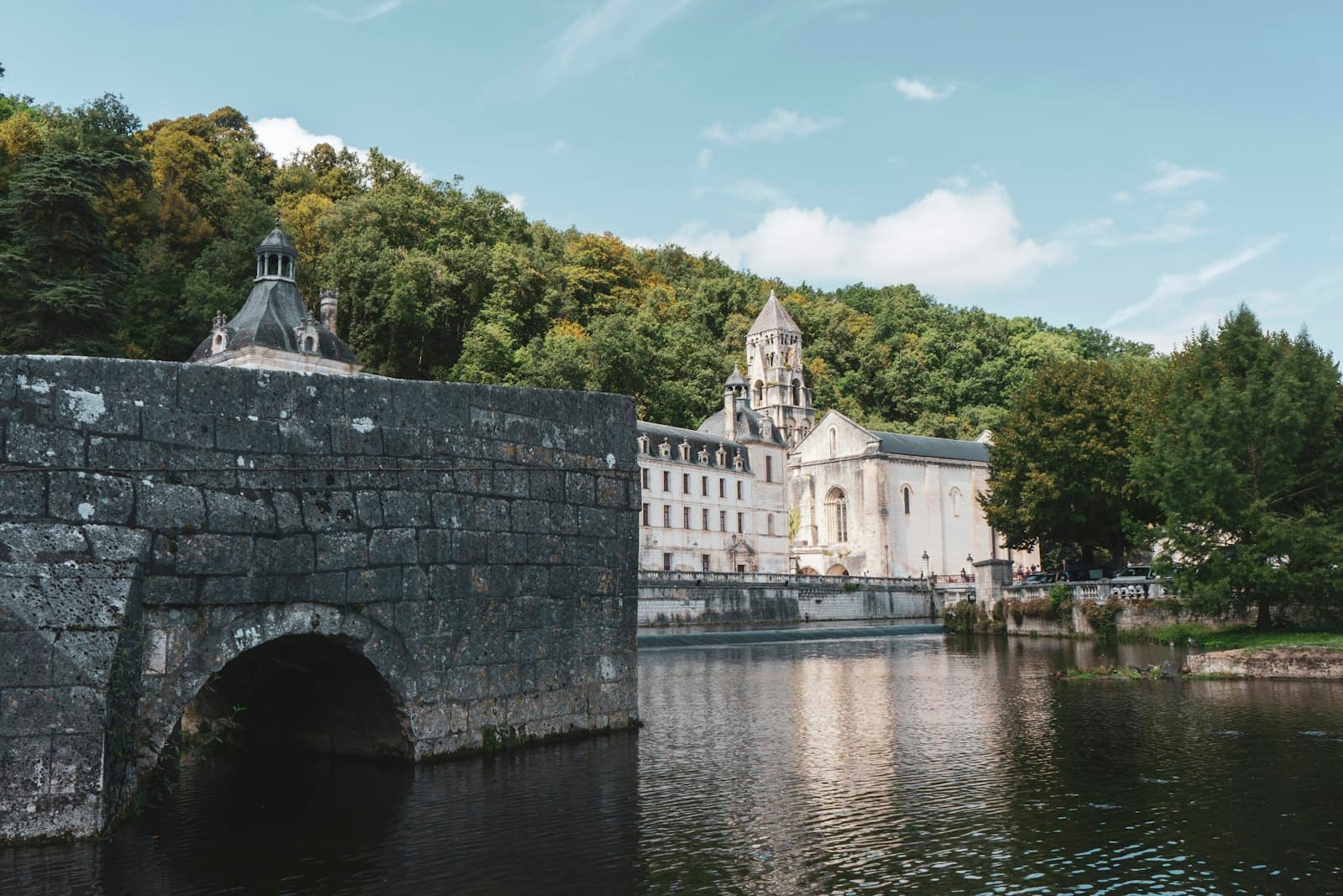 Brantôme — a large building sitting on the side of a river