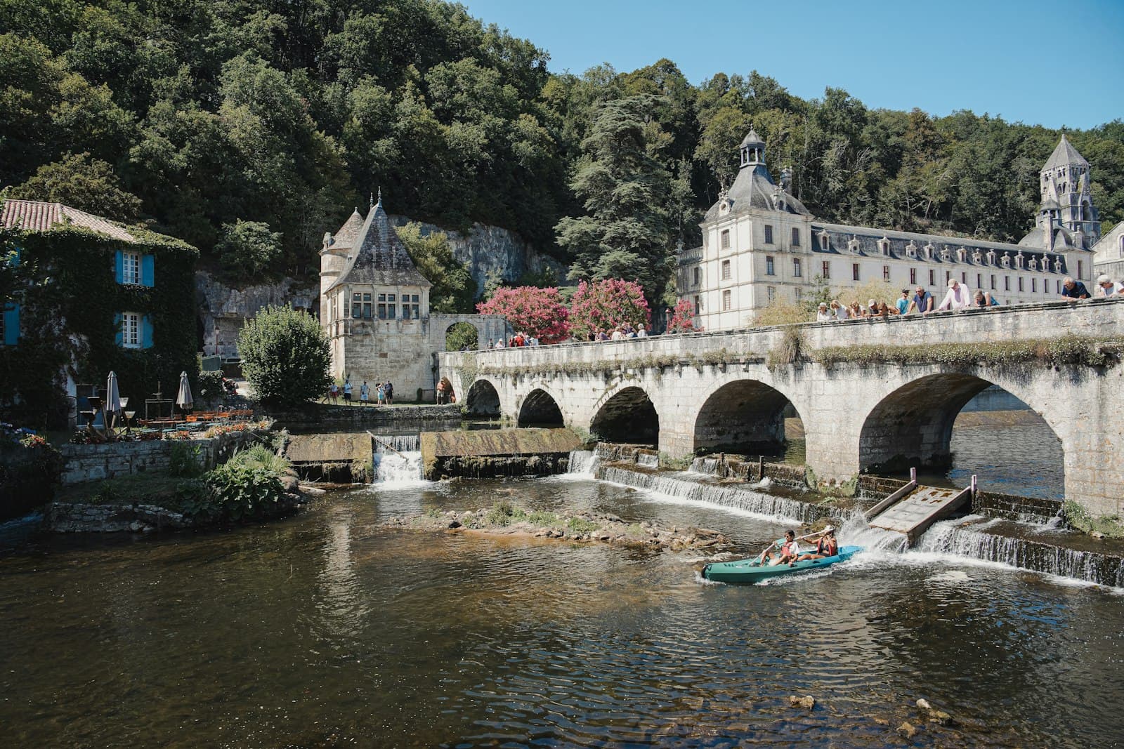 Brantôme — A scenic bridge crosses a river with buildings behind.