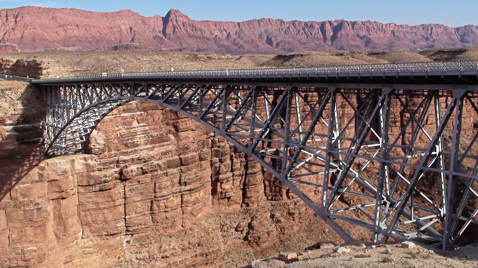 Breaux Bridge — A large bridge over a canyon with mountains in the background