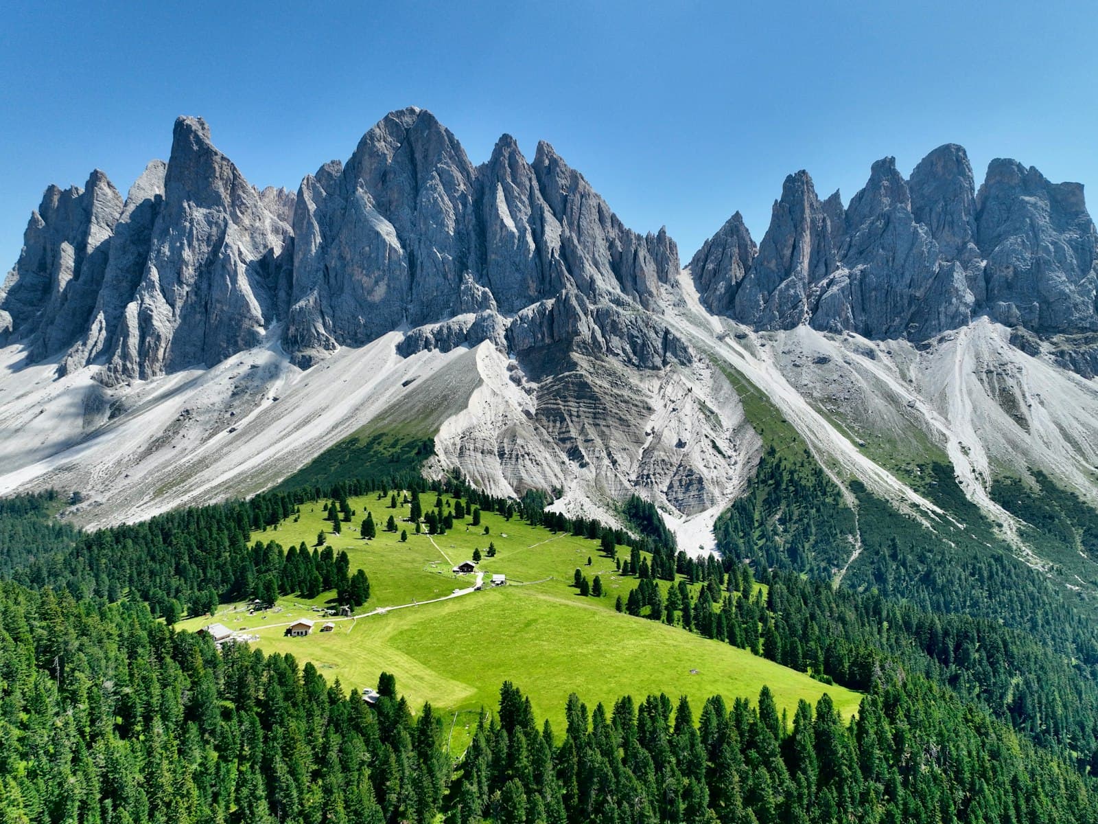 Bressanone — a green field in front of a mountain range